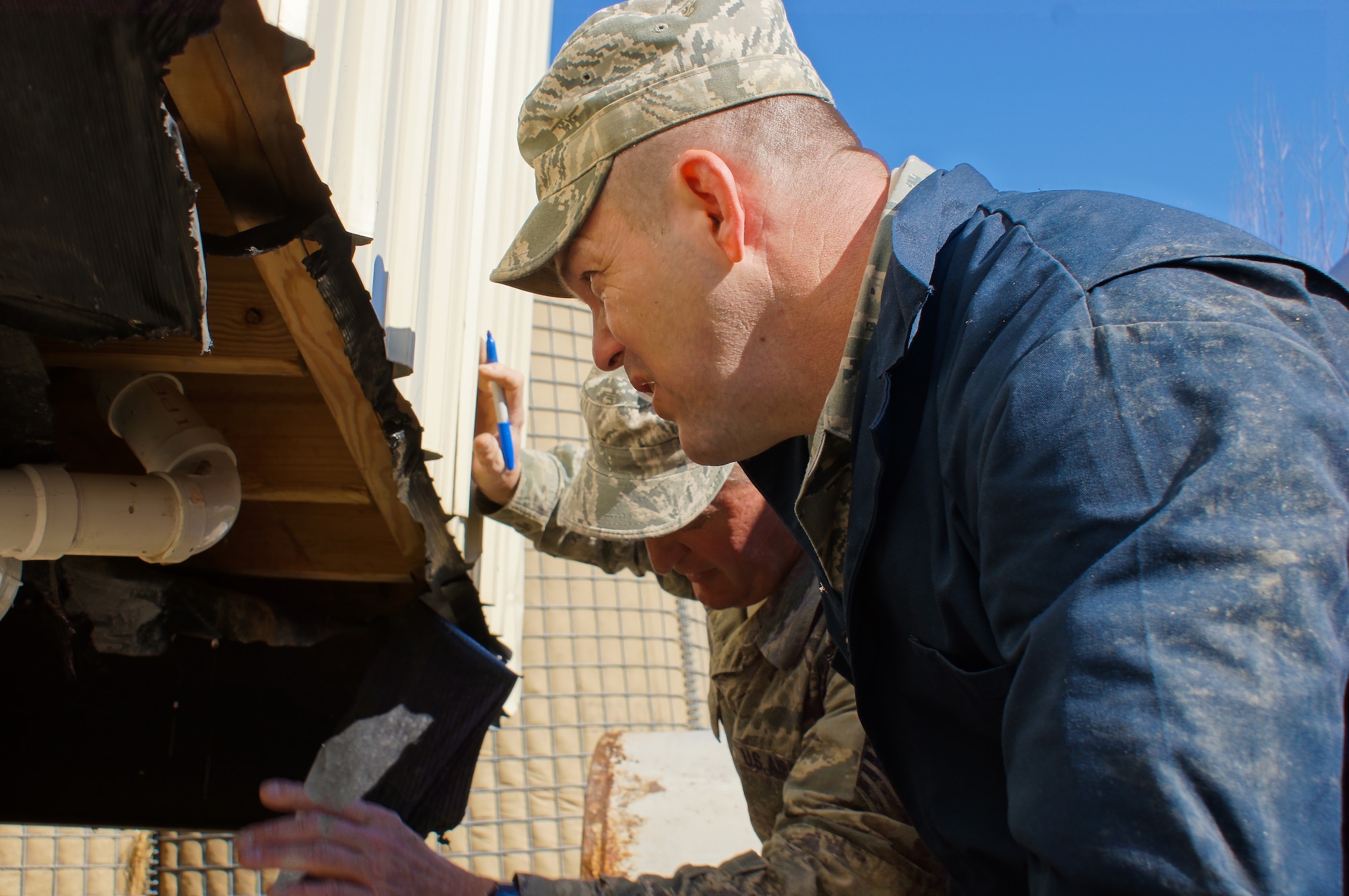 U.S. Air Force civil engineers from the 116th Civil Engineer Squadron, Georgia Air National Guard, inspect a portable latrine shower shave trailer at Camp William Hinds Boy Scout Camp, Raymond, Maine, April 22, 2015. The squadron, from Robins Air Force Base, Ga., spent two weeks at the camp as part of the Innovative Readiness Training program where they are the lead unit that kicked off a project to construct a new dining facility for the Boy Scout camp. The two week deployment provided the opportunity for the squadron to get real-world training similar to the way they will be deploying in the future. The Airmen set up nine tents, installed an entire electrical grid, renovated electrical, plumbing and HVAC systems on two shower shave trailers, and worked with the duration staff to ensure materials and equipment are on site to continue the mission for future rotations. (Contributed photo/Released)