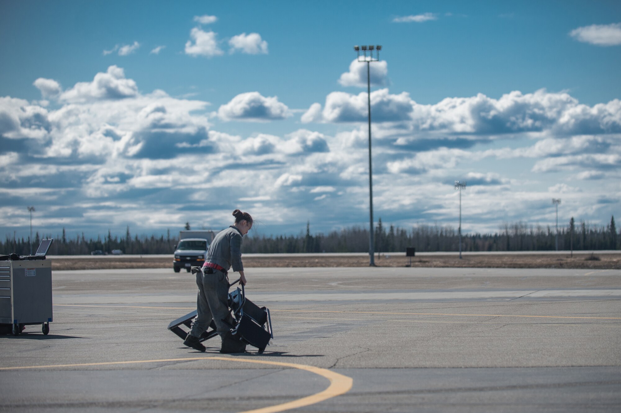 U.S. Air Force Senior Airman Michelle Park, a 354th Aircraft Maintenance Squadron assistant dedicated crew chief, removes a ladder from an F-16 Fighting Falcon at Eielson Air Force Base, Alaska, April 27, 2015. As a crew chief, Park is a tactical aircraft maintainer who ensures her assigned jet is ready to fly at a moments notice. (U.S. Air Force photo by Staff Sgt. Shawn Nickel/Released)