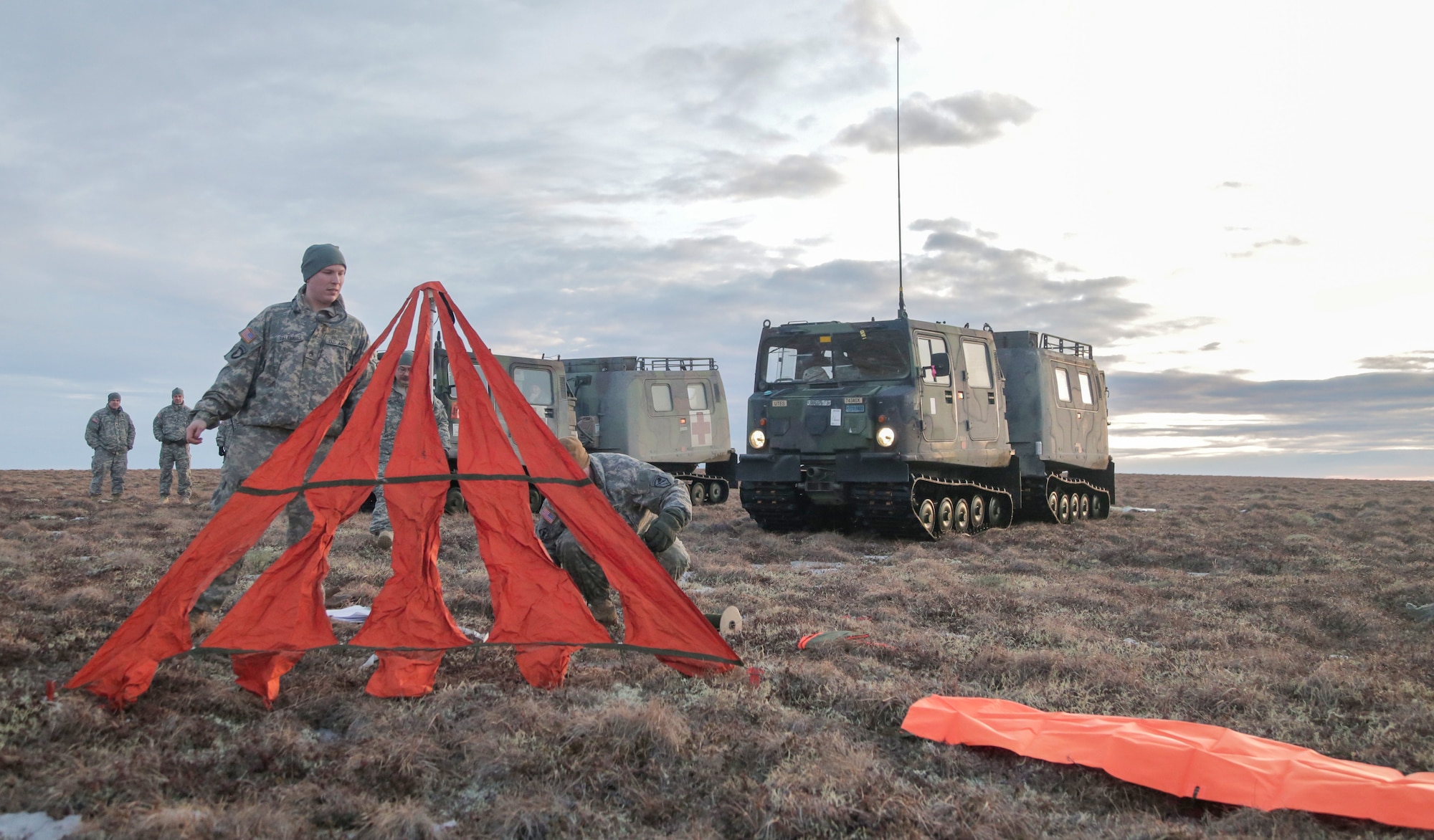 Alaska Army National Guardsmen with the 297th Cavalry Regiment, Charlie Company, Joint Base Elmendorf-Richardson, prepare a raised angle marker for a drop zone in order to ensure the safety of 31 Soldiers who are scheduled to participate in airborne operations in Bethel, Alaska. (U.S. Army National Guard photo by Sgt. Marisa Lindsay)