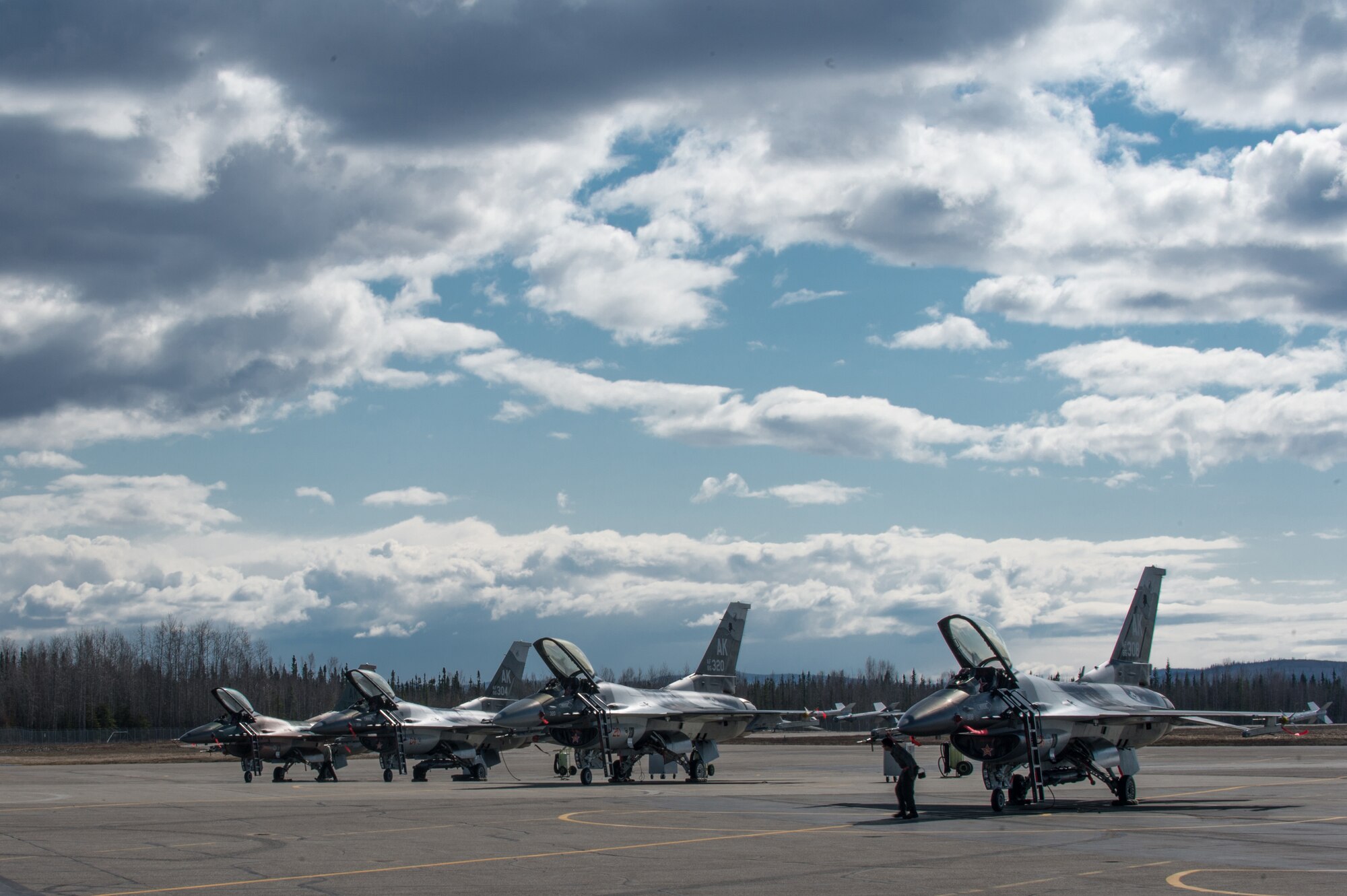 U.S. Air Force F-16 Fighting Falcons from the 18th Aggressor Squadron (AGRS) sit on the flight line April 28, 2015, at Eielson Air Force Base, Alaska. The 18th AGRS prepares joint and allied aircrews for combat through realistic threat replication training. (U.S. Air Force photo by Staff Sgt. Shawn Nickel/Released)