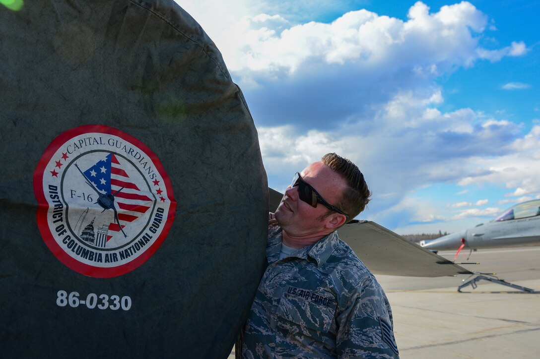 U.S. Air Force Tech. Sgt. Andrew Limke, a 113th Wing, District of Columbia Air National Guard crew chief, works on an F-16 Fighting Falcon at Eielson Air Force Base, Alaska, April 27, 2015. The unit is preparing to participate in RED FLAG-Alaska 15-2 large-force employment training. (U.S. Air Force photo by Staff Sgt. Shawn Nickel/Released)