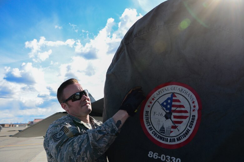 U.S. Air Force Tech. Sgt. Andrew Limke, a 113th Wing, District of Columbia Air National Guard crew chief, works on an F-16 Fighting Falcon at Eielson Air Force Base, Alaska, April 27, 2015. The unit is preparing to participate in RED FLAG-Alaska 15-2 large-force employment training. (U.S. Air Force photo by Staff Sgt. Shawn Nickel/Released)