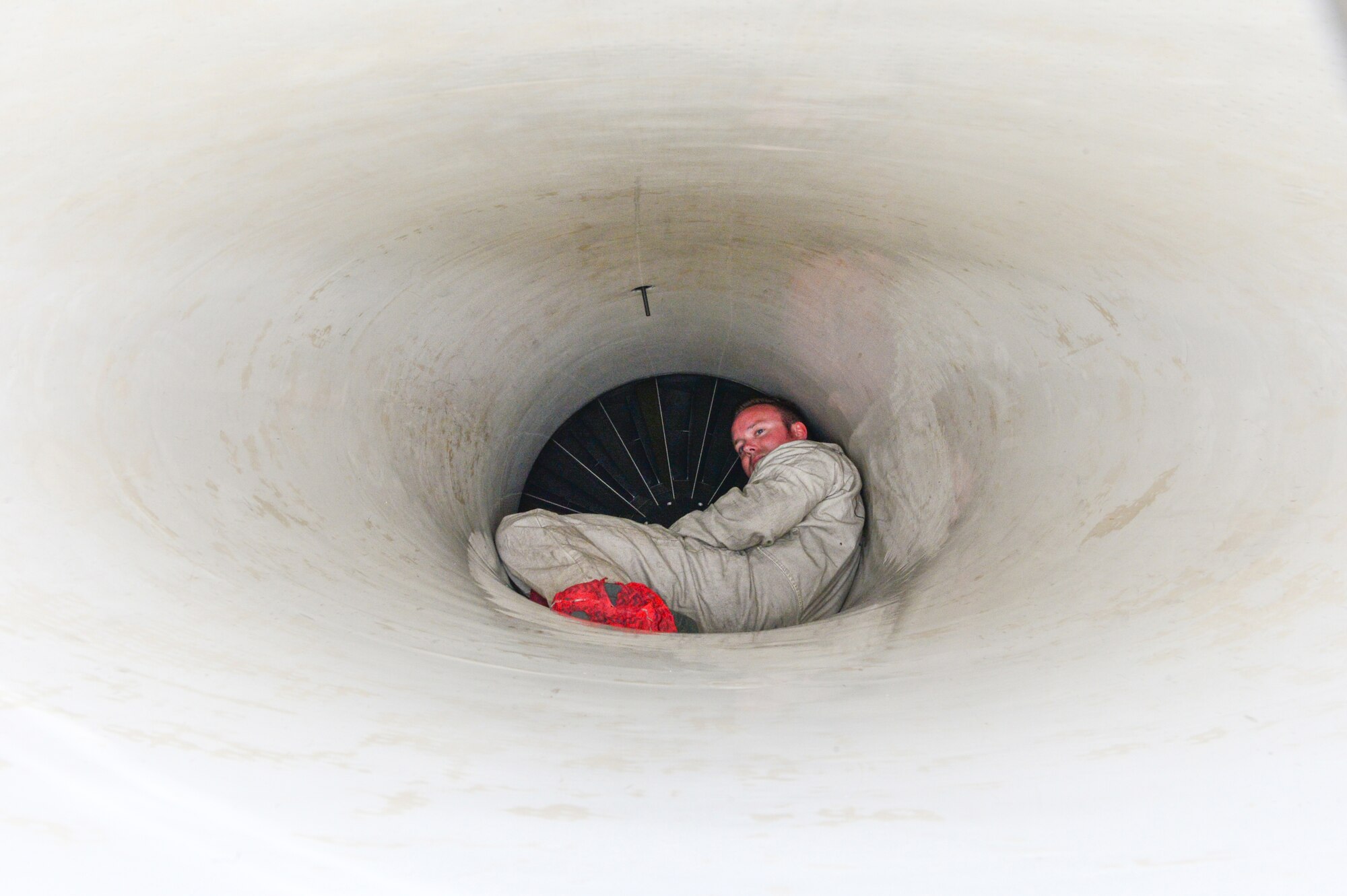 U.S. Air Force Tech. Sgt. Andrew Limke, a 113th Wing, District of Columbia Air National Guard crew chief, works inside the intake of an F-16 Fighting Falcon at Eielson Air Force Base, Alaska, April 27, 2015. The unit is preparing to participate in RED FLAG-Alaska 15-2 large-force employment training. (U.S. Air Force photo by Staff Sgt. Shawn Nickel/Released)