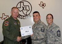 Master Sgt. Andrew Rodriguez, center, 47th Logistics Readiness Flight Supply Contracting Officer representative and superintendent, poses with Col. Darrell Judy, 47th Flying Training Wing vice commander, and Chief Master Sgt. Patricia Hickey, 47th Mission Support Group superintendent, after accepting the XLer of the Week award here April 22, 2015. The XLer is a weekly award chosen by wing leadership and is presented to those who consistently make outstanding contributions to their unit and Laughlin. (U.S. Air Force photo by Airman 1st Class Ariel D. Partlow)(Released)
