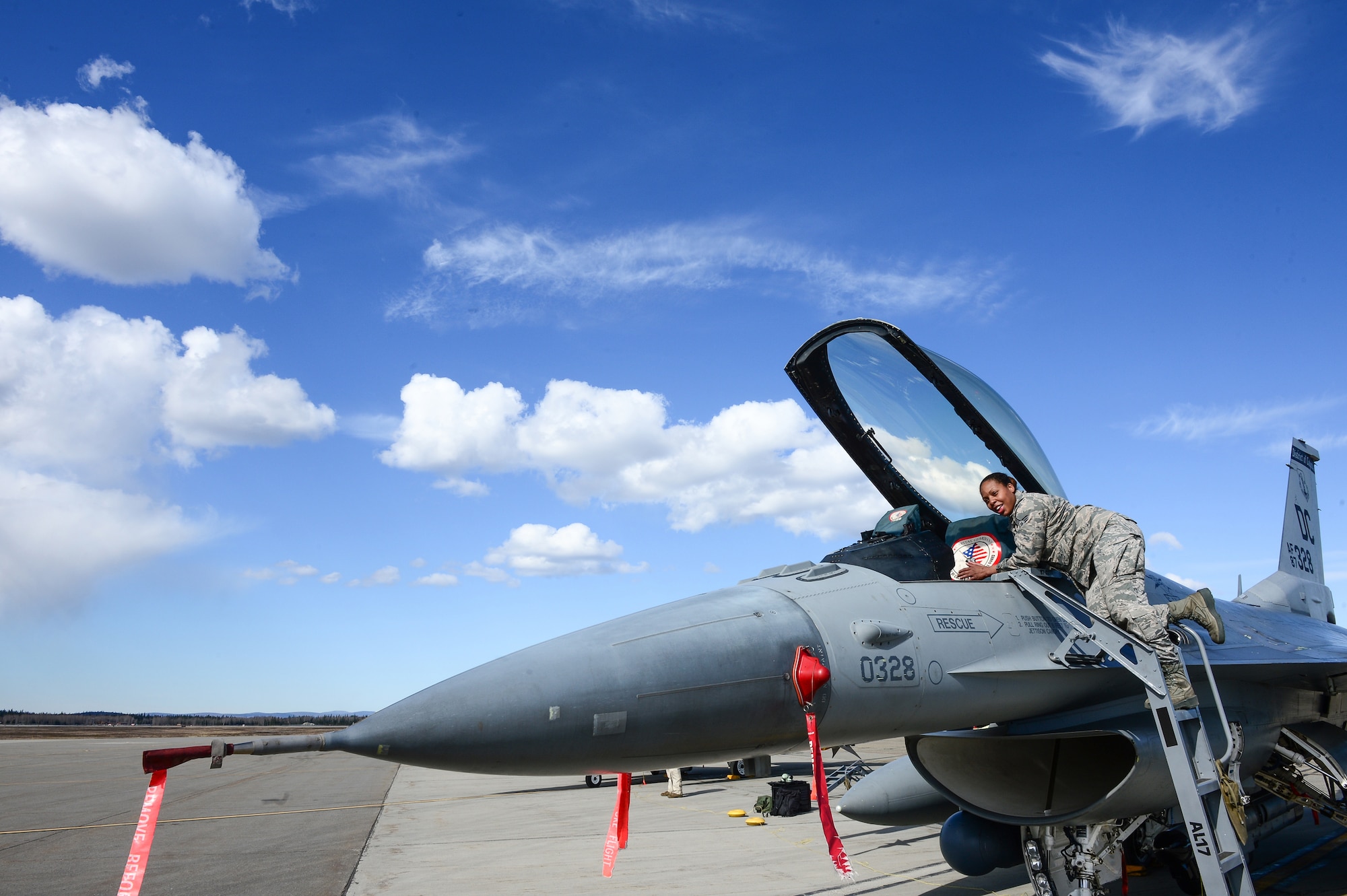 U.S. Air Force Senior Airman Sharone Gray, a 113th Wing, District of Columbia Air National Guard crew chief, works inside the cockpit of an F-16 Fighting Falcon at Eielson Air Force Base, Alaska, April 27, 2015. The unit is preparing to participate in RED FLAG-Alaska 15-2 large-force employment training. (U.S. Air Force photo by Staff Sgt. Shawn Nickel/Released)