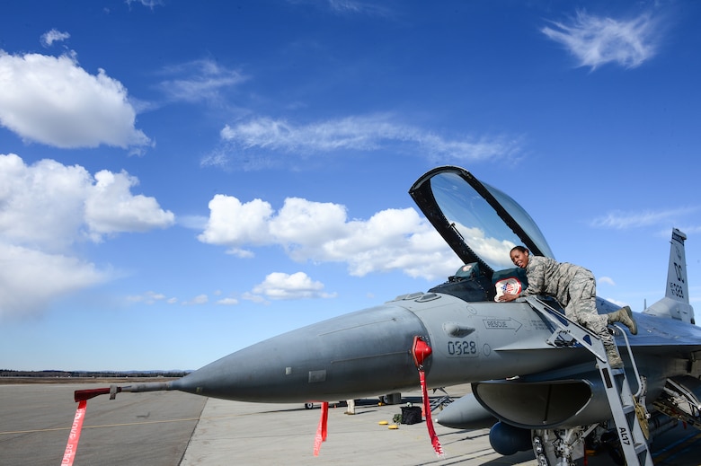 U.S. Air Force Senior Airman Sharone Gray, a 113th Wing, District of Columbia Air National Guard crew chief, works inside the cockpit of an F-16 Fighting Falcon at Eielson Air Force Base, Alaska, April 27, 2015. The unit is preparing to participate in RED FLAG-Alaska 15-2 large-force employment training. (U.S. Air Force photo by Staff Sgt. Shawn Nickel/Released)