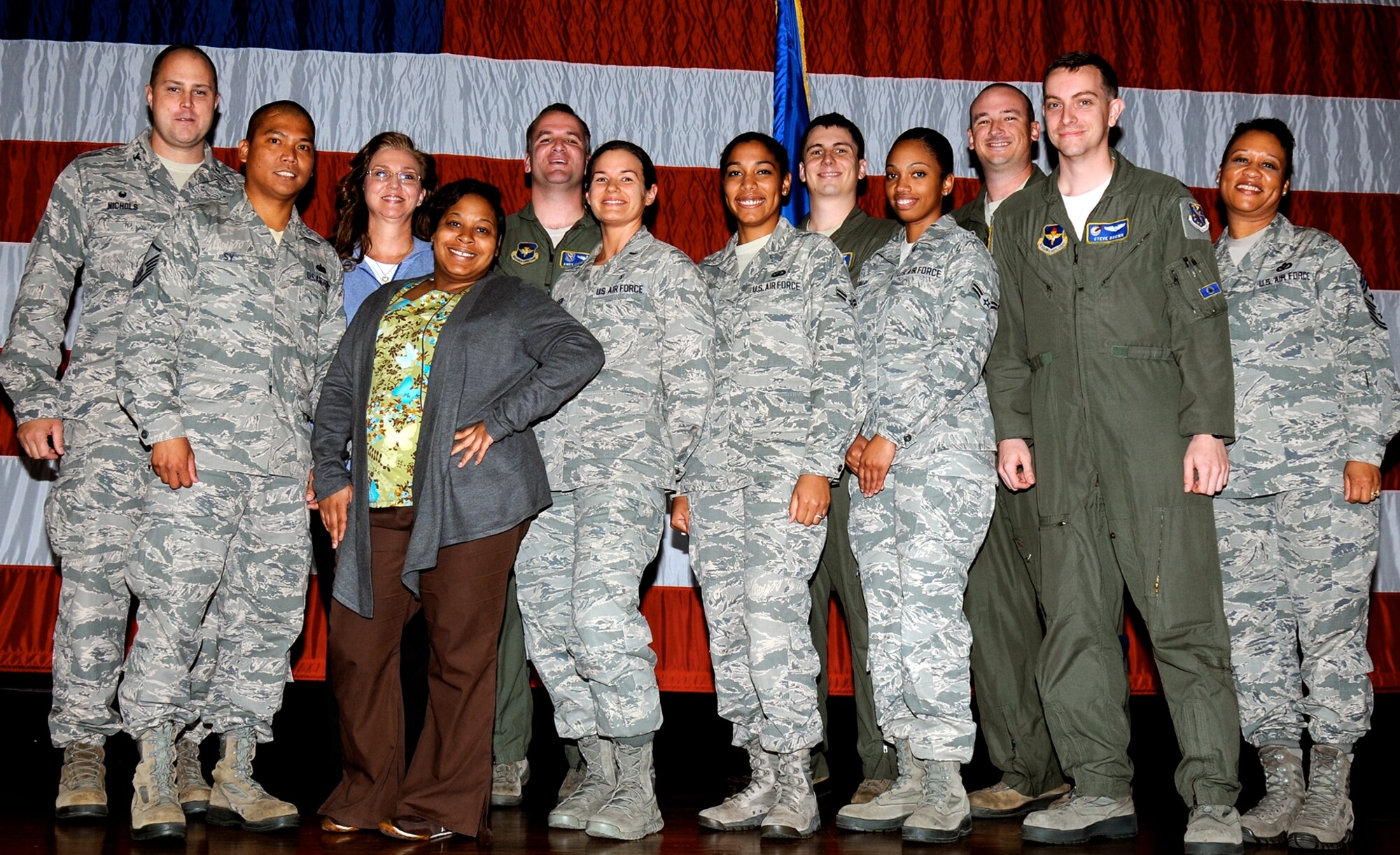 The 2015 first quarterly awards winners or their representatives pause for a photo on stage April 28 in the Kaye Auditorium on Columbus Air Force Base, Mississippi. The ceremony honored the wing’s outstanding professionals for the months of January through March 2015 whose drive, determination and dedication have earned them this recognition. (U.S. Air Force Photo/Sharon Ybarra)
