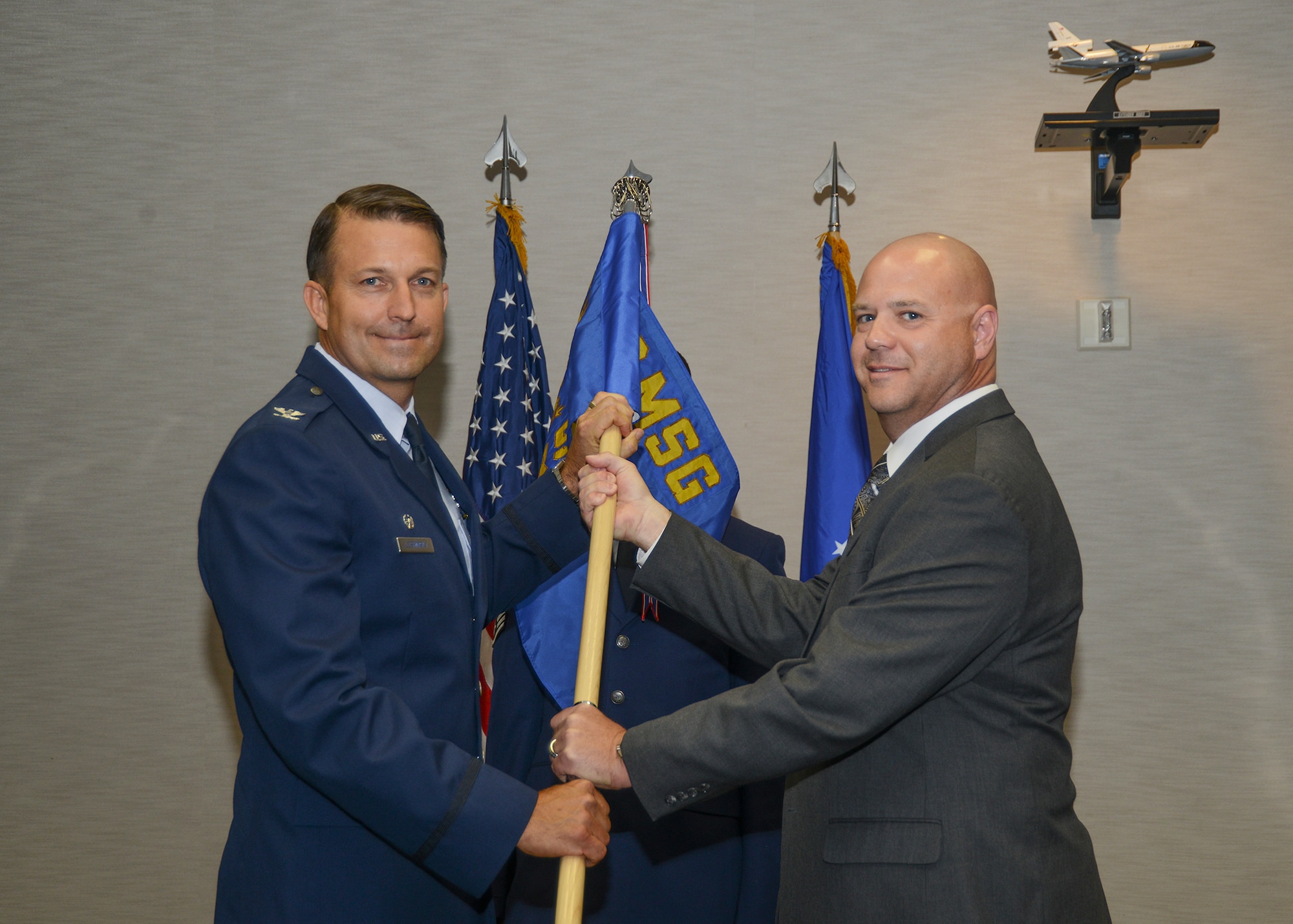 Col. Eric Leshinsky 412th Mission Support Group commander, presents the 412th Logistics Readiness Squadron guidon to their new director, Michael Sears, Jr. (U.S. Air Force photo by Rebecca Amber)