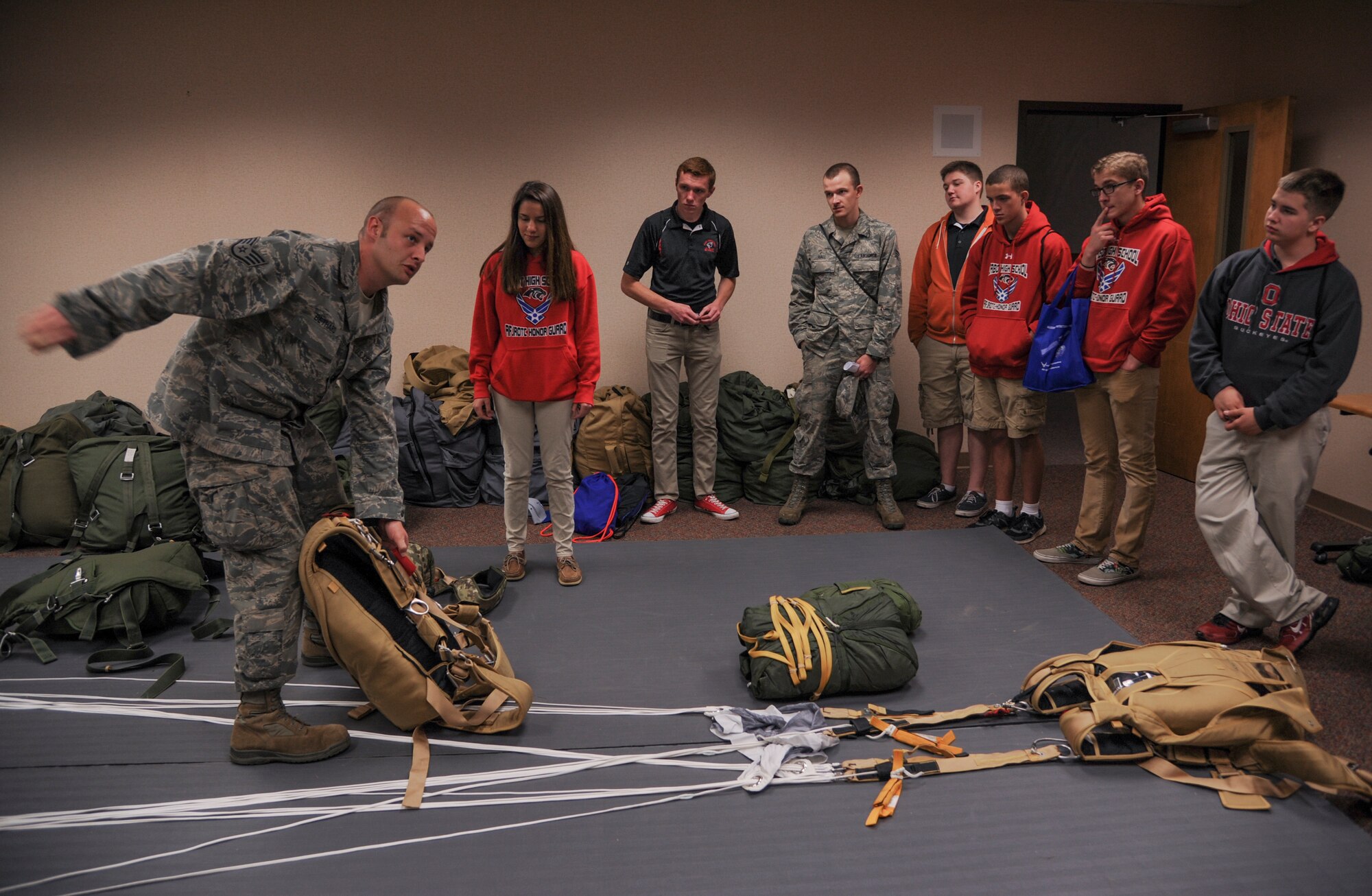 Staff Sgt. Aaron Bethard, a 19th Operations Support Squadron aircrew flight equipment technician, shows Air Force Junior ROTC cadets how parachutes are packed April 23, 2015, at Little Rock Air Force Base, Ark. The demonstration was part of a JROTC Expo that provided an overview of Air Force career fields that contribute to combat airlift. (U.S. Air Force photo by Senior Airman Harry Brexel)