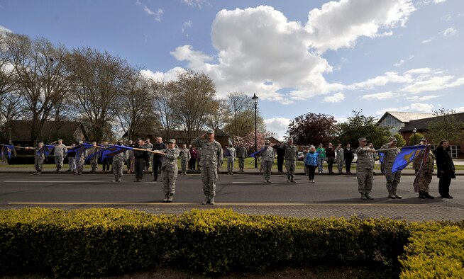 Team Mildenhall Airmen and local community leaders pay respect to the U.S. flag and Royal Air Force ensign during a retreat ceremony for Honorary Commanders’ Day April 28, 2015, on RAF Mildenhall, England. Local community leaders joined the formation to experience the retreat ceremony and to wrap up the day’s events. (U.S. Air Force photo by Airman 1st Class Kyla Gifford/Released)