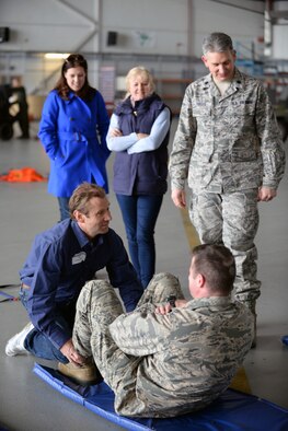 Adam Kendall, left, Imperial War Museum events manager and the 100th Operations Support Squadron honorary commander, assists U.S. Air Force Lt. Col. Jay Butterfield, right, 100th OSS commander, while he completes sit-ups April 28, 2015, during the Honorary Commander’s Day event on RAF Mildenhall, England. Throughout the day, honorary commanders and their military commanders participated in competitive team building events, viewed aircraft and met with Airmen. (U.S. Air Force photo by Senior Airman Christine Halan/Released)