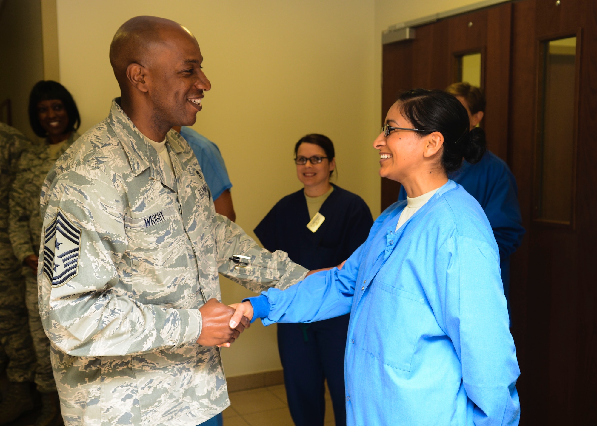 U.S. Air Force Chief Master Sgt. Kaleth O. Wright, 3rd Air Force command chief, congratulates one of Aviano’s star performers during a hospital tour April 29, 2015, at Aviano Air Base, Italy. Wright and Maj. Gen. Christopher Bence, 3rd AF vice commander, visited multiple organizations and learned about Aviano Airmen’s concerns and achievements. (U.S. Air Force photo by Senior Airman Austin Harvill/Released)