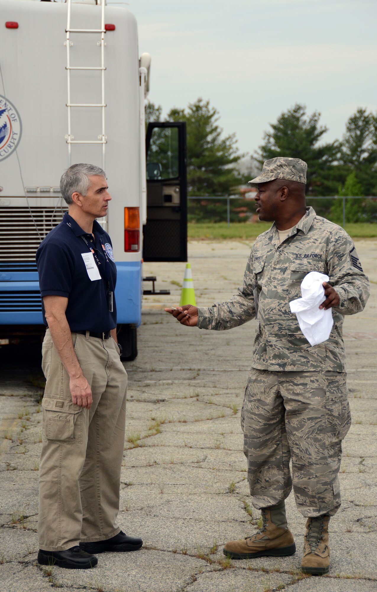 U.S. Air Force Master Sgt. Timothy Jones, Superintendent of Operations for the 156th Aeromedical Evacuation Squadron, meets with Robert Nicholson, Jones civilian counterpart with the Transportation Security Administration, during a North Carolina Command and Communications rally held in Greensboro, N.C. April 10, 2015. NCANG partnered with more than twenty Emergency Management agencies and provided a Mobile Emergency Operations Center to test communications during a natural disaster exercise. The Rally allowed for North Carolina Emergency Management agencies to connect, and understand the assets available for any state or possibly national incidents and disasters that may occur. (U.S. Air National Guard photo by Senior Airman Laura Montgomery, 145th Public Affairs/Released)