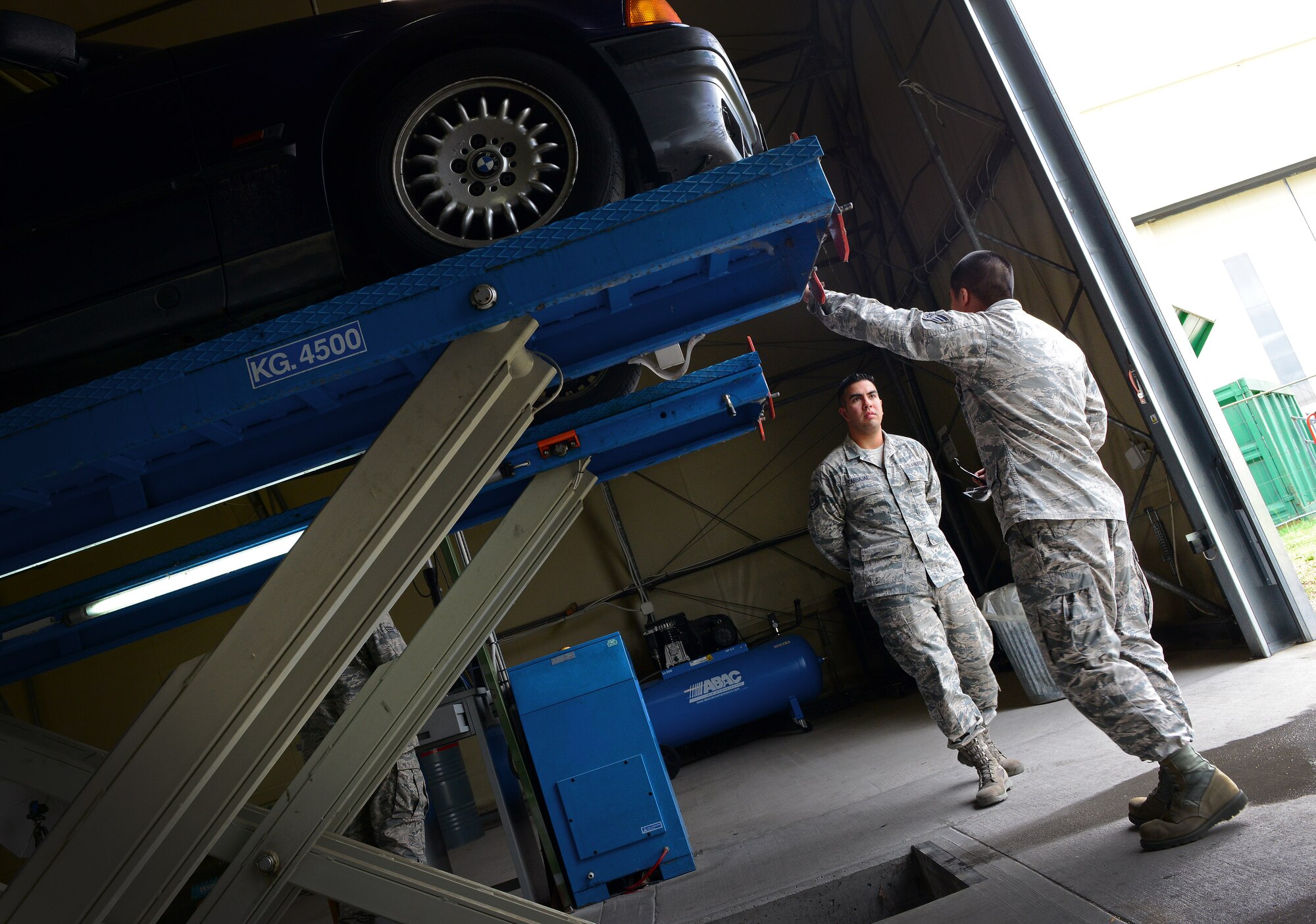 U.S. Air Force Senior Airman Justin Bow, 31st Logistics Readiness Squadron vehicle maintainer, speaks with a customer about their vehicle, April 28, 2015, at Aviano Air Base, Italy. Vehicle maintainers are responsible for checking vehicles’ brakes, tires and lights. The section inspected more than 5,000 privately owned vehicles last year.  (U.S. Air Force photo by Senior Airman Matthew Lotz/Released)