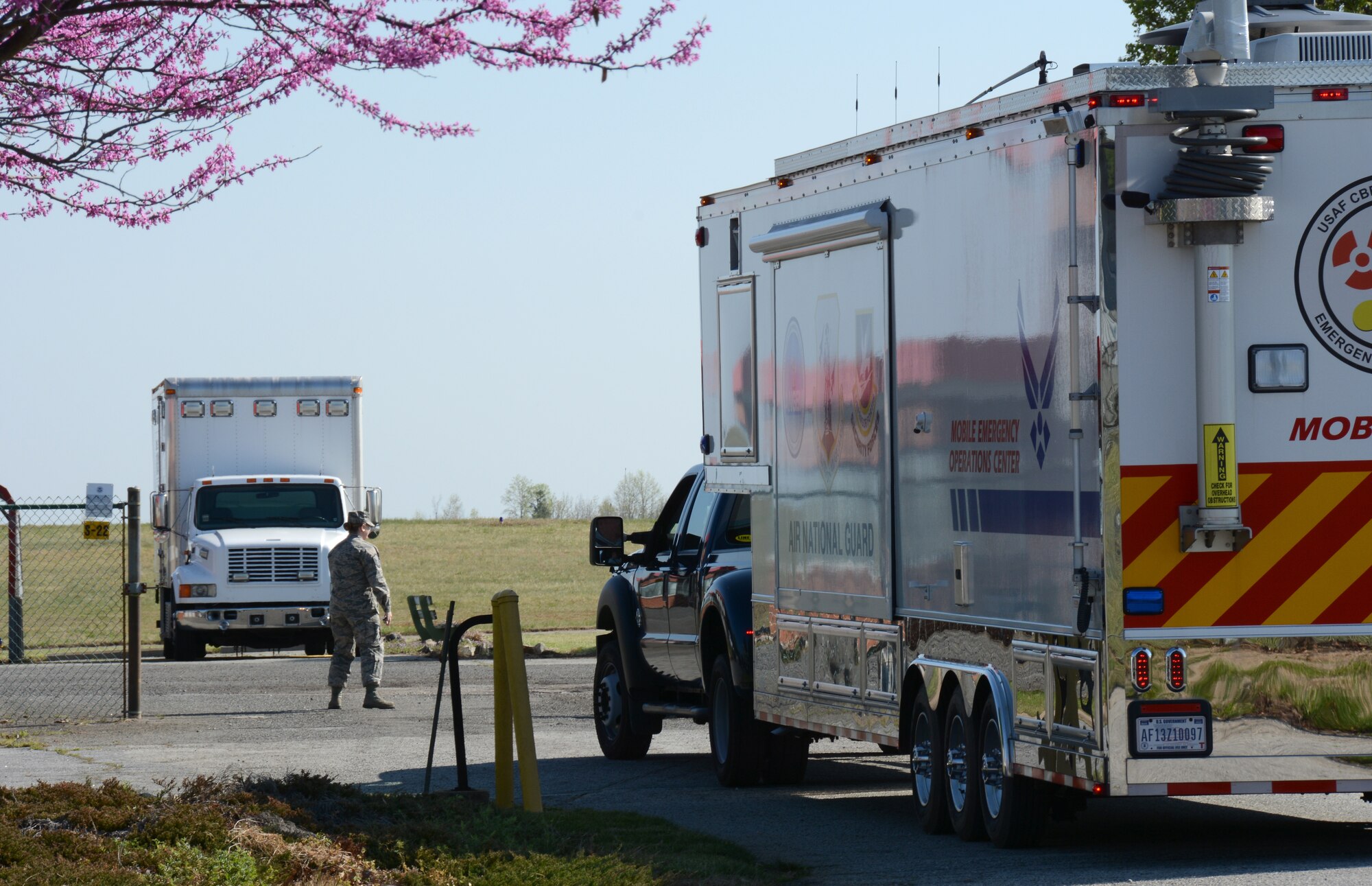 U.S. Air Force Master Sgt. Rebecca Tongen, Installation Emergency Manager for the145th Airlift Wing guides EM contractor Mark Fow as he drives the North Carolina Air National Guard, Mobile Emergency Operations Center (MEOC) onto the flight-line of local airport in Greensboro, N.C., April 8, 2015. NCANG partnered with more than twenty Emergency Management agencies over a two-day period, testing communications during a natural disaster exercise and to showcase each agency’s capabilities. The MEOC provides the community’s incident commanders with emergency response support and interoperable communications such as video-teleconferencing, satellite internet, a weather station, a long range on-scene camera and various radio systems. (U.S. Air National Guard photo by Senior Airman Laura Montgomery, 145th Public Affairs/Released)