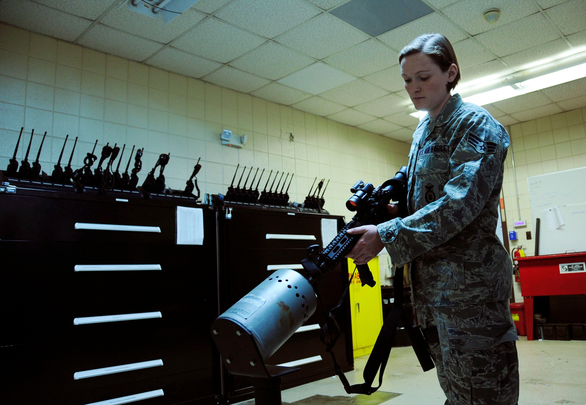 U.S. Air Force Senior Airman Kristine Koch, 145th Security Forces Squadron, safely utilizes a clearing barrel before issuing an M4 rifle during unit training at the North Carolina Air National Guard base, Charlotte Douglas Intl. Airport, Mar 21, 2015. Koch, who completed her first Professional Military Education milestone, Feb 12, 2015, as a distinguished graduate from Airman Leadership School has been with 145th SFS since Oct 2012. (U.S. Air National Guard photo by Master Sgt. Patricia F. Moran, 145th Public Affairs/Released)