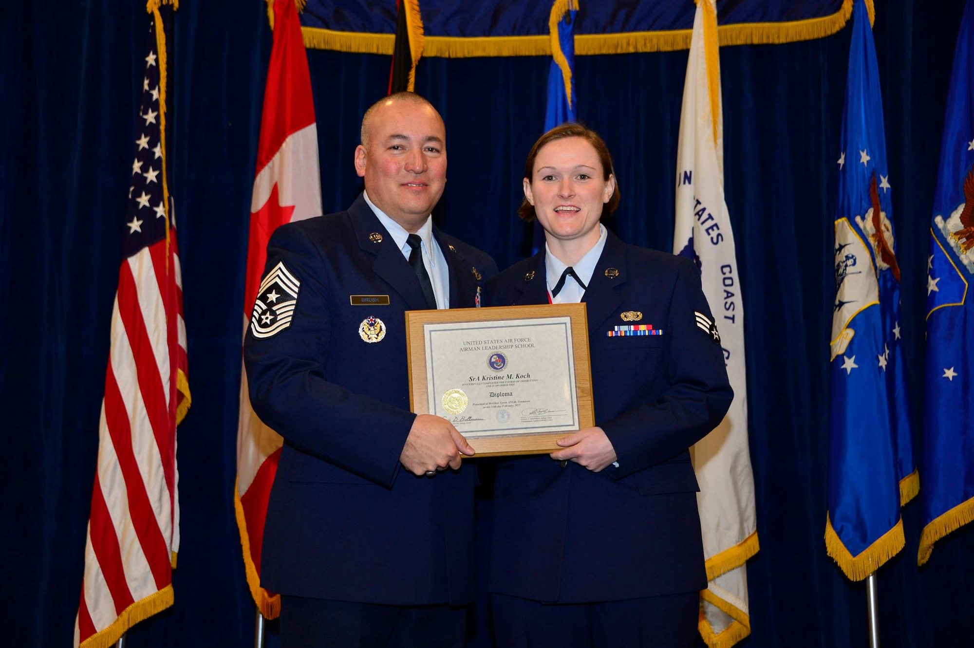 U.S. Air Force Chief Master Sgt. Mitchell Brush, senior enlisted advisor to the Chief, National Guard Bureau, recognizes Senior Airman Kristine Koch as a distinguished graduate for Airman Leadership School, 15-3. Feb. 12, 2015, at the Paul H. Lankford Enlisted PME Center, I.G. Brown Training and Education Center. (U.S. Air National Guard photo by Senior Master Sgt. Paul Mann/Released)
