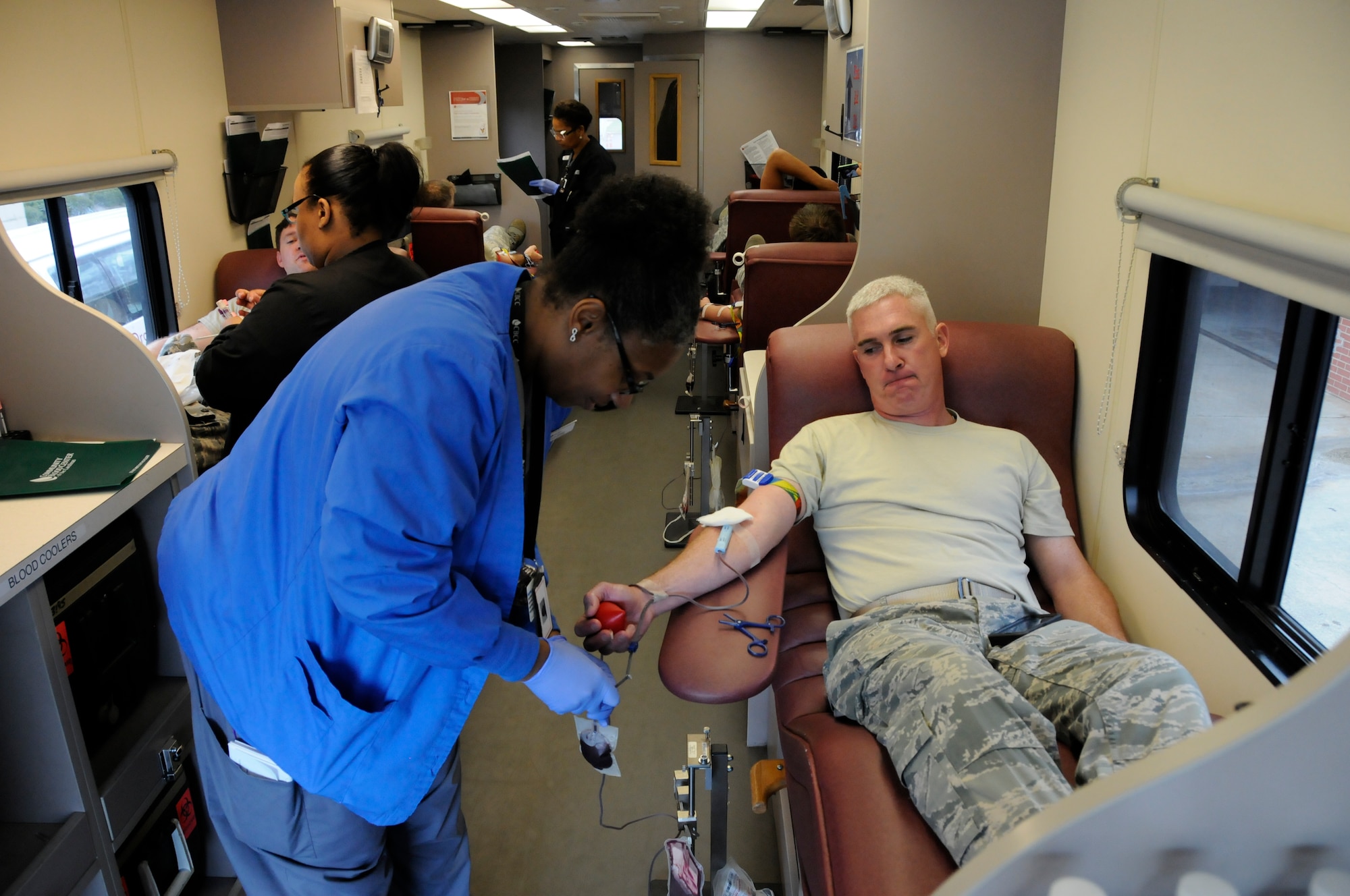 U. S. Air Force Maj. Paul Kurts, 145th Airlift Wing, Public Affairs Officer, donates blood inside the Community Blood Center of the Carolinas mobile unit, during a blood drive held at the North Carolina Air National Guard base, Charlotte Douglas Intl. Airport, April 18, 2015. The blood donated by airmen at CBCC stays in the community helping patients in local hospitals. Donating one pint takes an hour or less, and in the end one walks away having saved up to three lives.  (U.S. Air National Guard photo by Master Sgt. Patricia F. Moran, 145th Public Affairs/Released) 