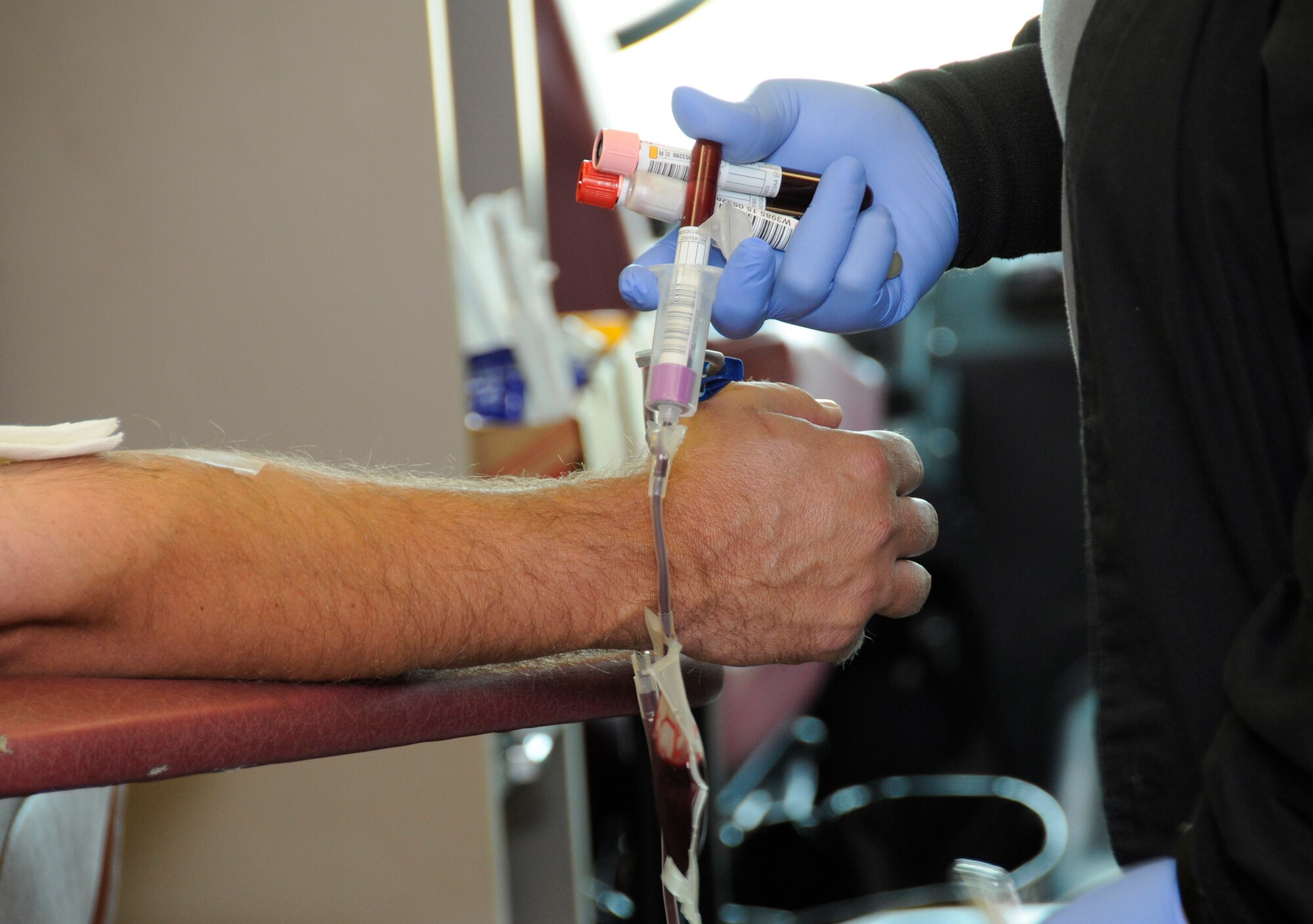 A nurse uses a vial to collect blood being donated by U. S. Air Force Master Sgt. Todd Latour, 145th Civil Engineer Squadron, during a blood drive held at the North Carolina Air National Guard base, Charlotte Douglas Intl. Airport, April 18, 2015. Community Blood Center of the Carolinas is an organization that supplies blood to local hospitals in the Charlotte area. Donating one pint takes an hour or less, and in the end one walks away having saved up to three lives.  (U.S. Air National Guard photo by Master Sgt. Patricia F. Moran, 145th Public Affairs/Released)
