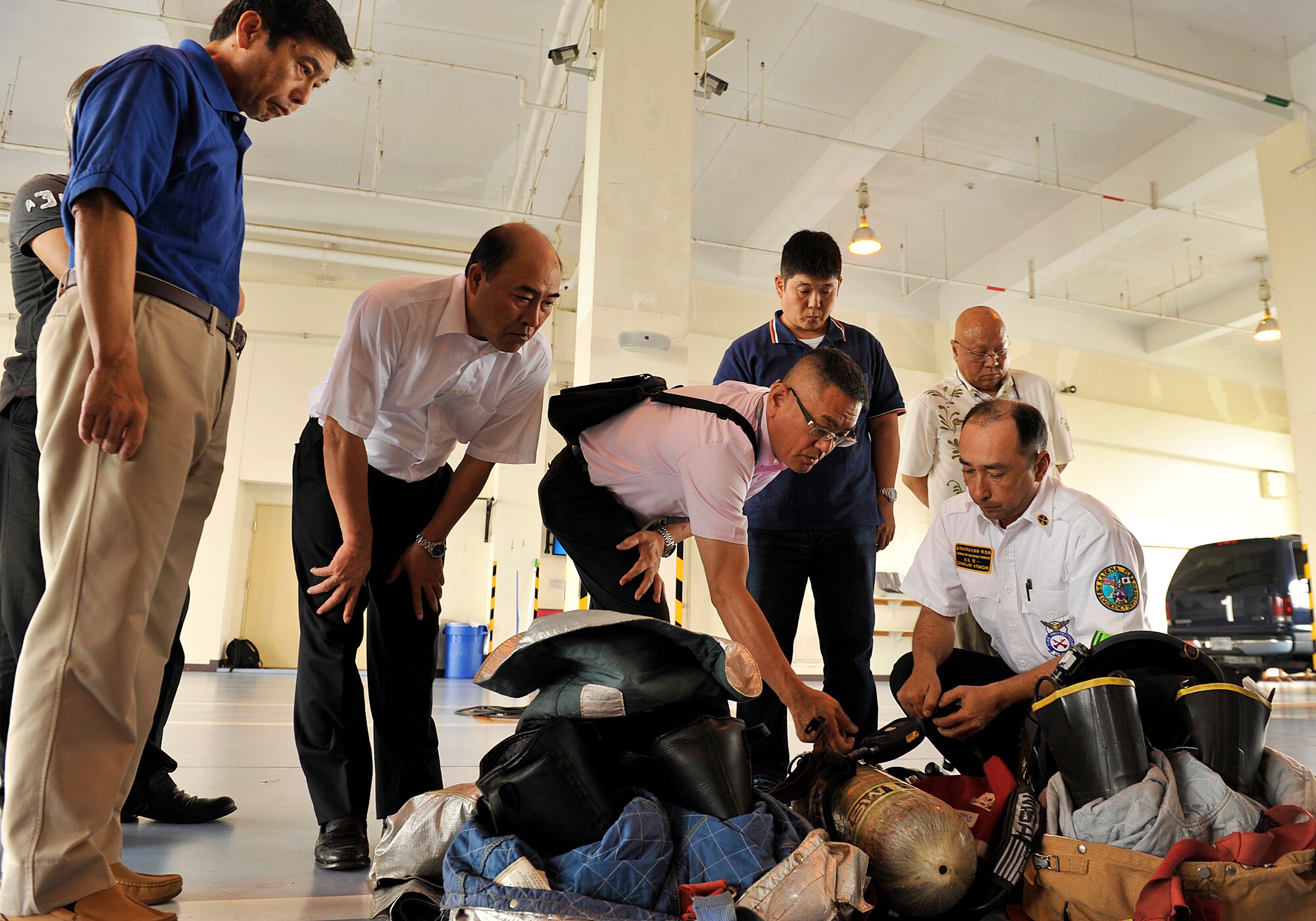 Members from the Civil Aviation Bureau, Naha Airport, observe the displays of the fire rescue equipment during their visit on Kadena Air Base, Japan, April 29, 2015. Eight members from the Civil Aviation Bureau, Naha airport, visited the Kadena fire department to broaden their understanding of the career field. (U.S. Air Force photo by Naoto Anazawa)