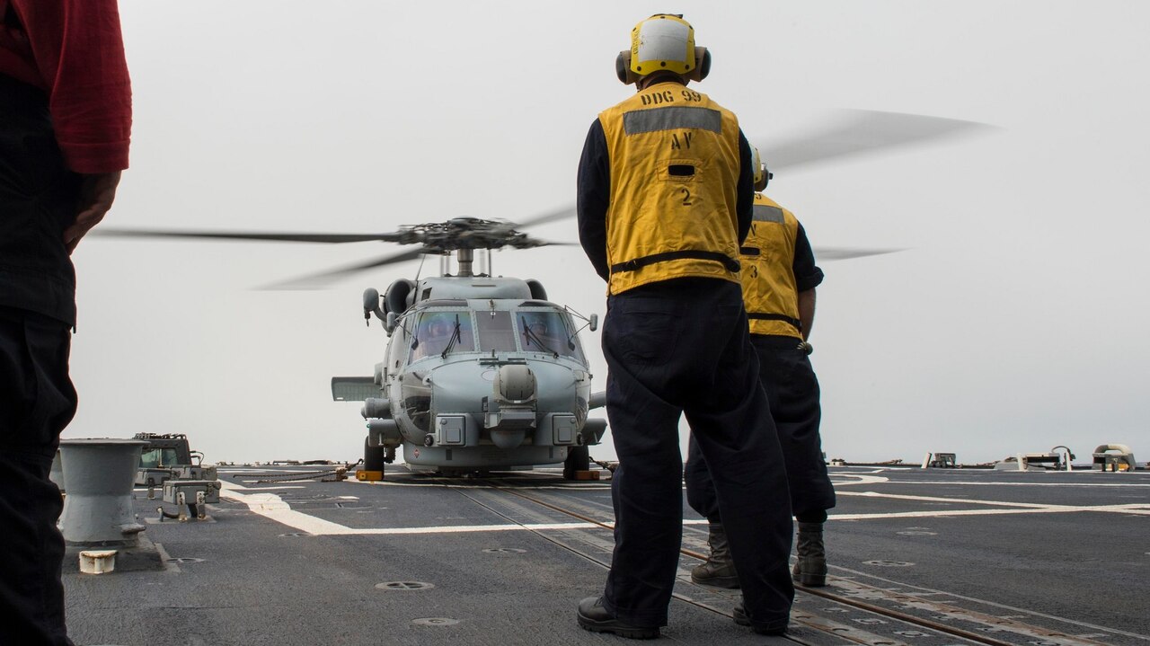 Sailors assigned to the Arleigh Burke-class guided-missile destroyer USS Farragut prepare to launch a MH-60R Sea Hawk helicopter assigned to Helicopter Maritime Strike Squadron 46, April 15, 2015. Farragut is deployed in the U.S. 5th Fleet area of operations supporting Operation Inherent Resolve strike operations in Iraq and Syria as directed, as well as maritime security operations and theater security cooperation efforts in the region. U.S. Navy photo by Petty Officer 3rd Class Jackie Hart