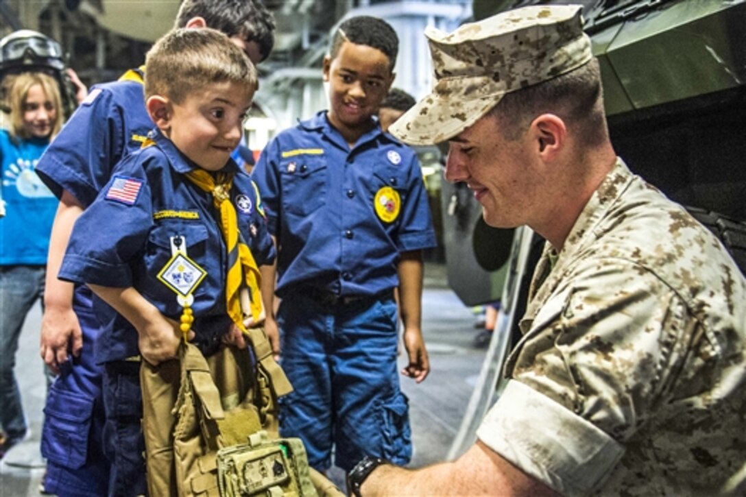 A Boy Scout lifts body armor during a ship tour on the amphibious assault ship USS Wasp in New Orleans, April 25, 2015. The Wasp is participating in Fleet Week New Orleans 2015, a weeklong collaboration with the community and ships representing the U.S. Navy, U.S. Marine Corps, U.S. Coast Guard, the British navy and the Canadian navy. 