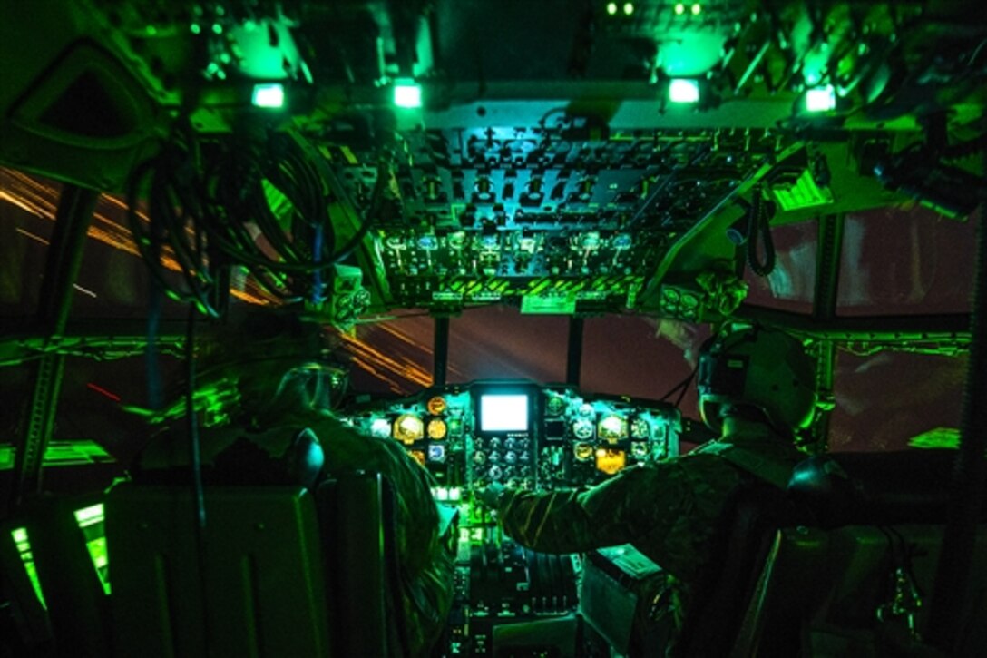 An Air Force pilot and co-pilot return to base in an AC-130W Stinger II after a live-fire mission to support Emerald Warrior on Hurlburt Field, Fla., April 27, 2015. Emerald Warrior is the Defense Department's only irregular warfare exercise which allows joint and combined partners to train together and prepare for contingency operations. The airmen are assigned to the 73rd Special Operations Squadron. 