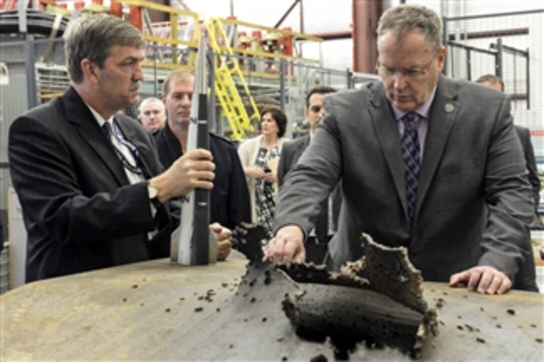 Deputy Defense Secretary Bob Work examines the damage from a high-velocity projectile during a visit to the Naval Surface Warfare Center Dahlgren Division in Dahlgren, Va., April 30, 2015.