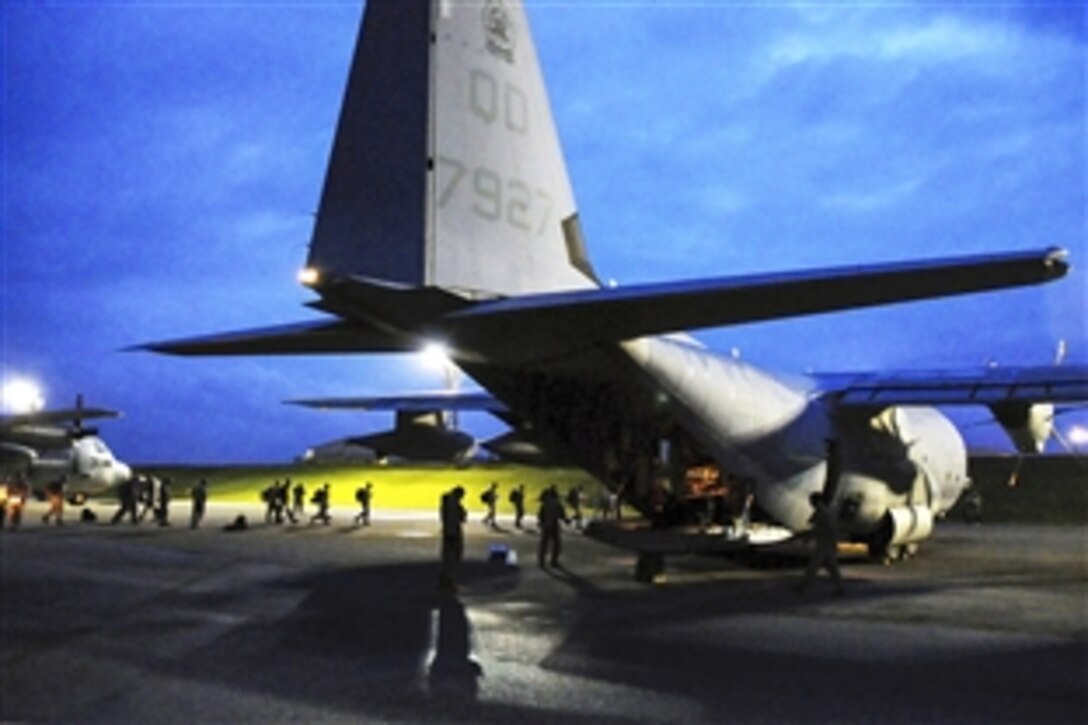 Members of a U.S. Pacific Command Joint Humanitarian Assistance Survey Team load supplies onto a U.S. Marine Corps C-130 on Kadena Air Base, Japan, April 29, 2015. The team is deploying to Nepal to help with relief efforts for earthquake victims. Airmen worked through the night to load the team’s 20-plus members and gear for the departure.