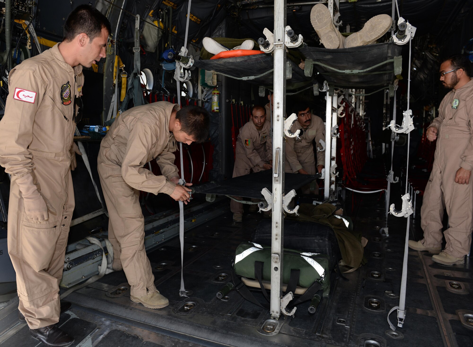 Members of the Afghan National Army medical evacuation team practice hands on MEDEVAC training with Train, Advise, Assist Command-Air advisors in a C-130H Hercules aircraft July 29, 2015, at Hamid Karzai International Airport, Kabul, Afghanistan. The TAAC-Air advisors host weekly training with the Afghan flight medics, with assistance from U.S. Air Force aeromedical evacuation subject matter experts. (U.S. Air Force photo by Senior Airman Cierra Presentado/Released)