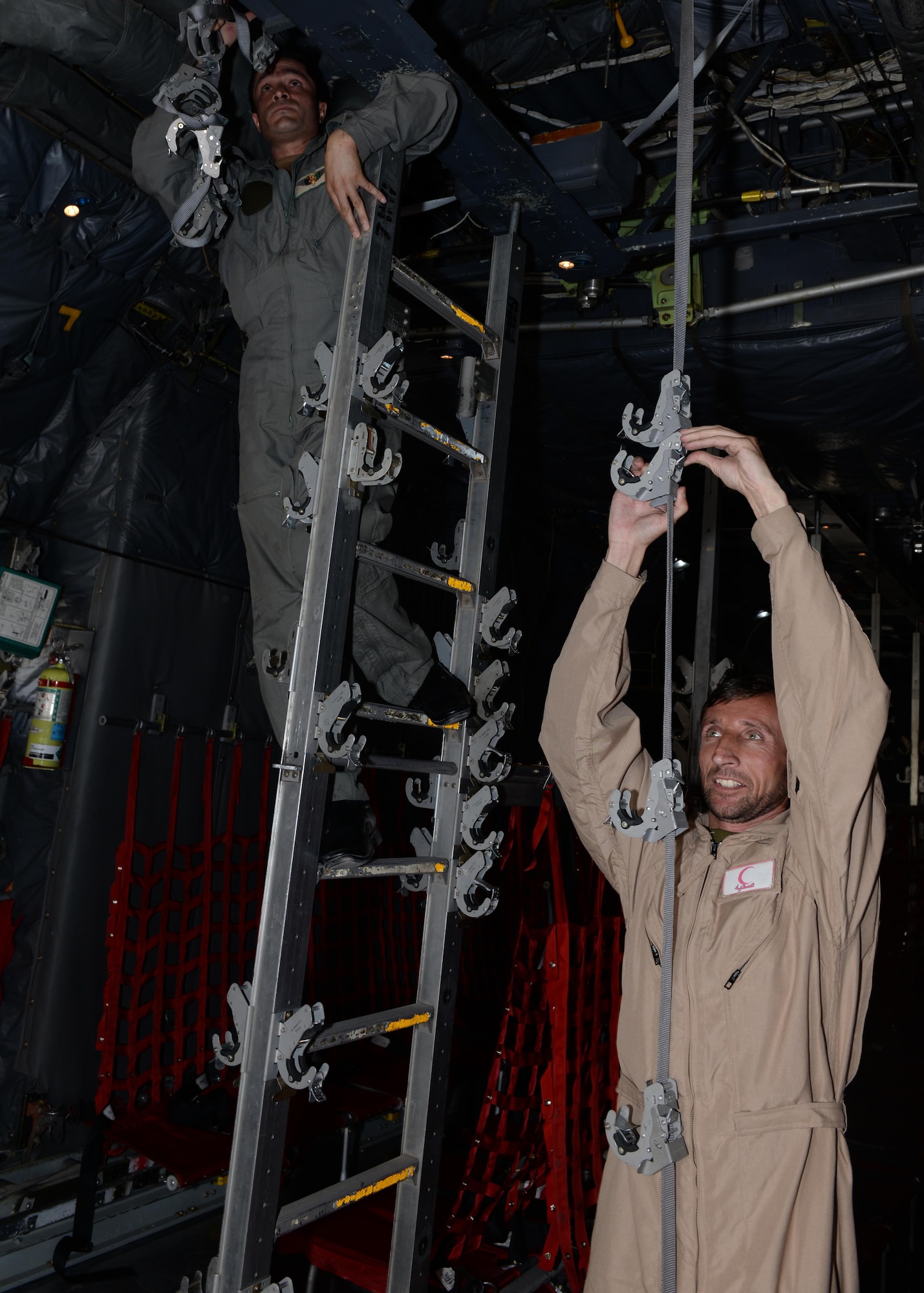 Members of the Afghan National Army medical evacuation team practice hands on MEDEVAC training with Train, Advise, Assist Command-Air advisors in a C-130H Hercules aircraft July 29, 2015, at Hamid Karzai International Airport, Kabul, Afghanistan. The TAAC-Air advisors host weekly training with the Afghan flight medics, with assistance from U.S. Air Force aeromedical evacuation subject matter experts. (U.S. Air Force photo by Senior Airman Cierra Presentado/Released)