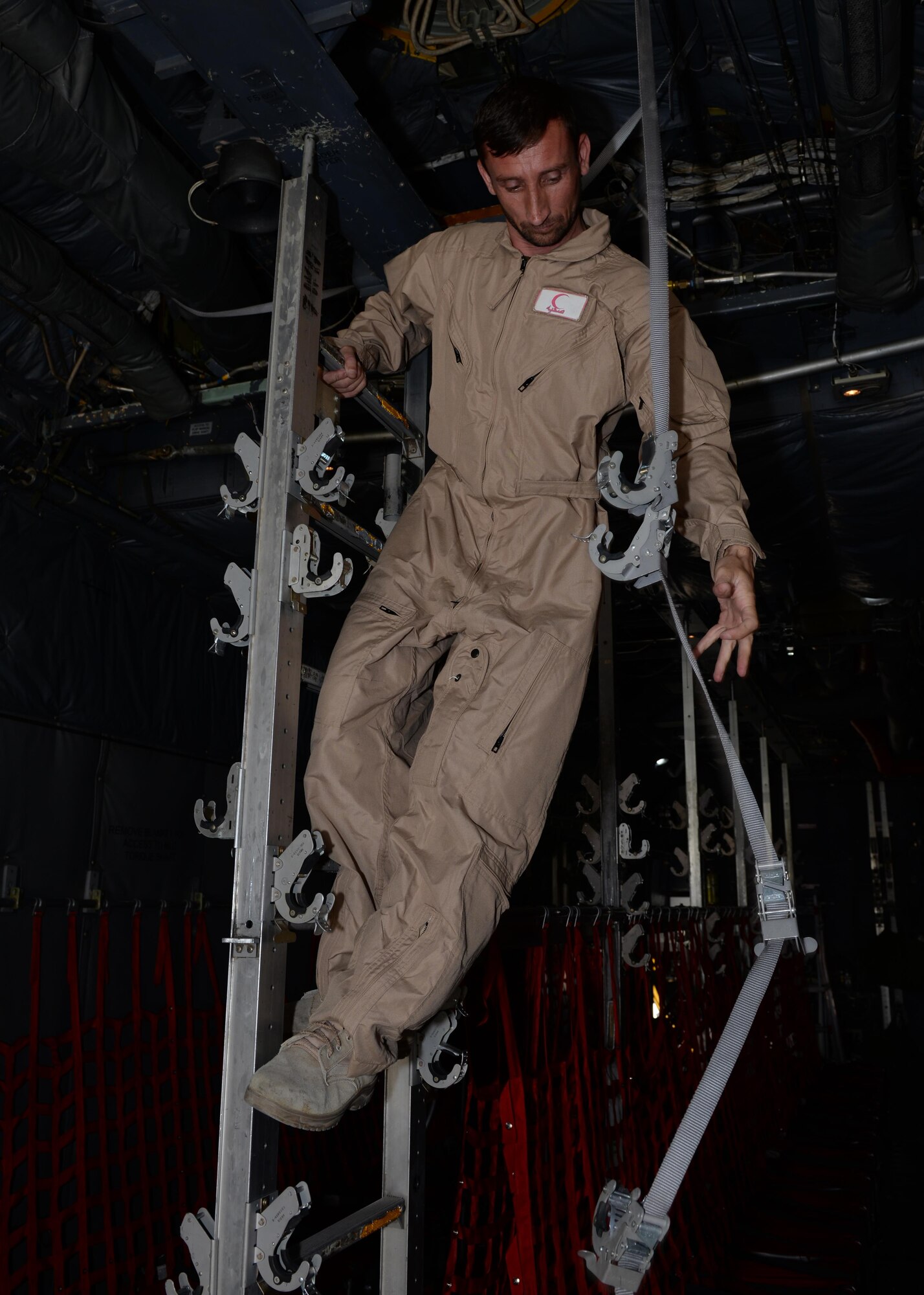 An Afghan National Army medical evacuation team member practices hands on MEDEVAC training in a C-130H Hercules aircraft July 29, 2015, at Hamid Karzai International Airport, Kabul, Afghanistan. The Train, Advise, Assist Command-Air advisors host weekly training with the Afghan flight medics with assistance from U.S. Air Force aeromedical evacuation subject matter experts. (U.S. Air Force photo by Senior Airman Cierra Presentado/Released)