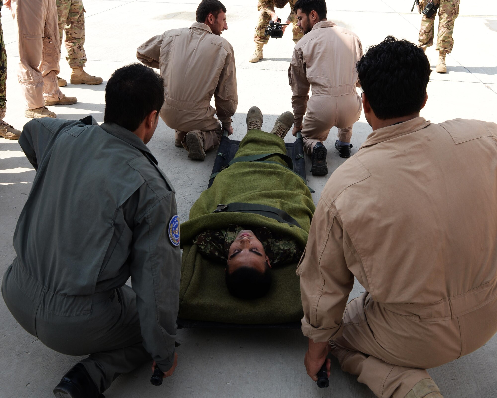 Members of the Afghan National Army medical evacuation team practices hands on MEDEVAC training with Train, Advise, Assist Command-Air advisors July 29, 2015, at Hamid Karzai International Airport, Kabul, Afghanistan. The TAAC-Air advisors host weekly training with the Afghan flight medics, with assistance from U.S. Air Force aeromedical evacuation subject matter experts. (U.S. Air Force photo by Senior Airman Cierra Presentado/Released)