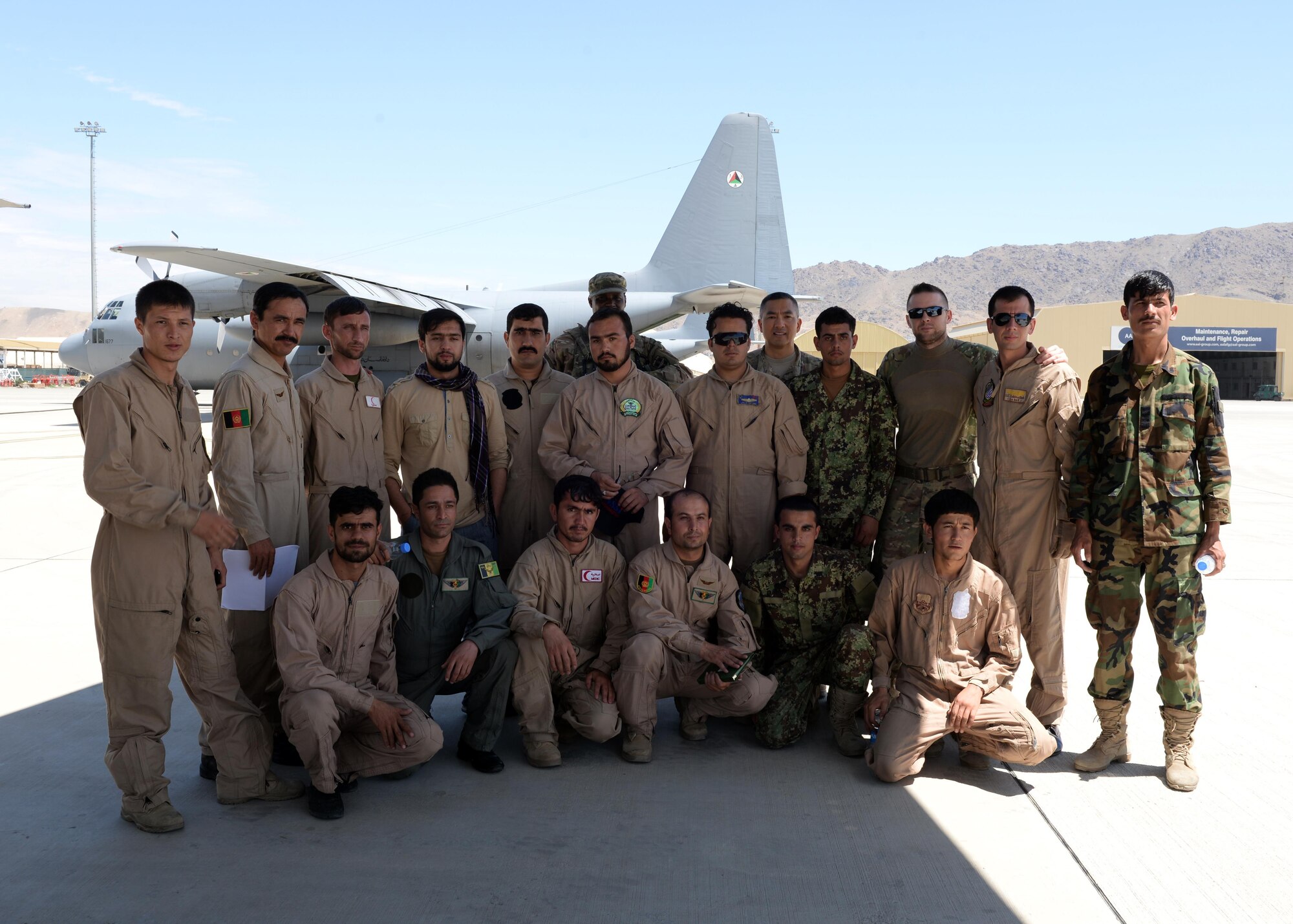 Members of the Train, Advise, Assist Command-Air and Afghan National Army medical evacuation team members pose for a group photo after performing hands on MEDEVAC training July 29, 2015, at Hamid Karzai International Airport, Kabul, Afghanistan. The TAAC-Air advisors host weekly training with the Afghan flight medics, with assistance from U.S. Air Force aeromedical evacuation subject matter experts. (U.S. Air Force photo by Senior Airman Cierra Presentado/Released)