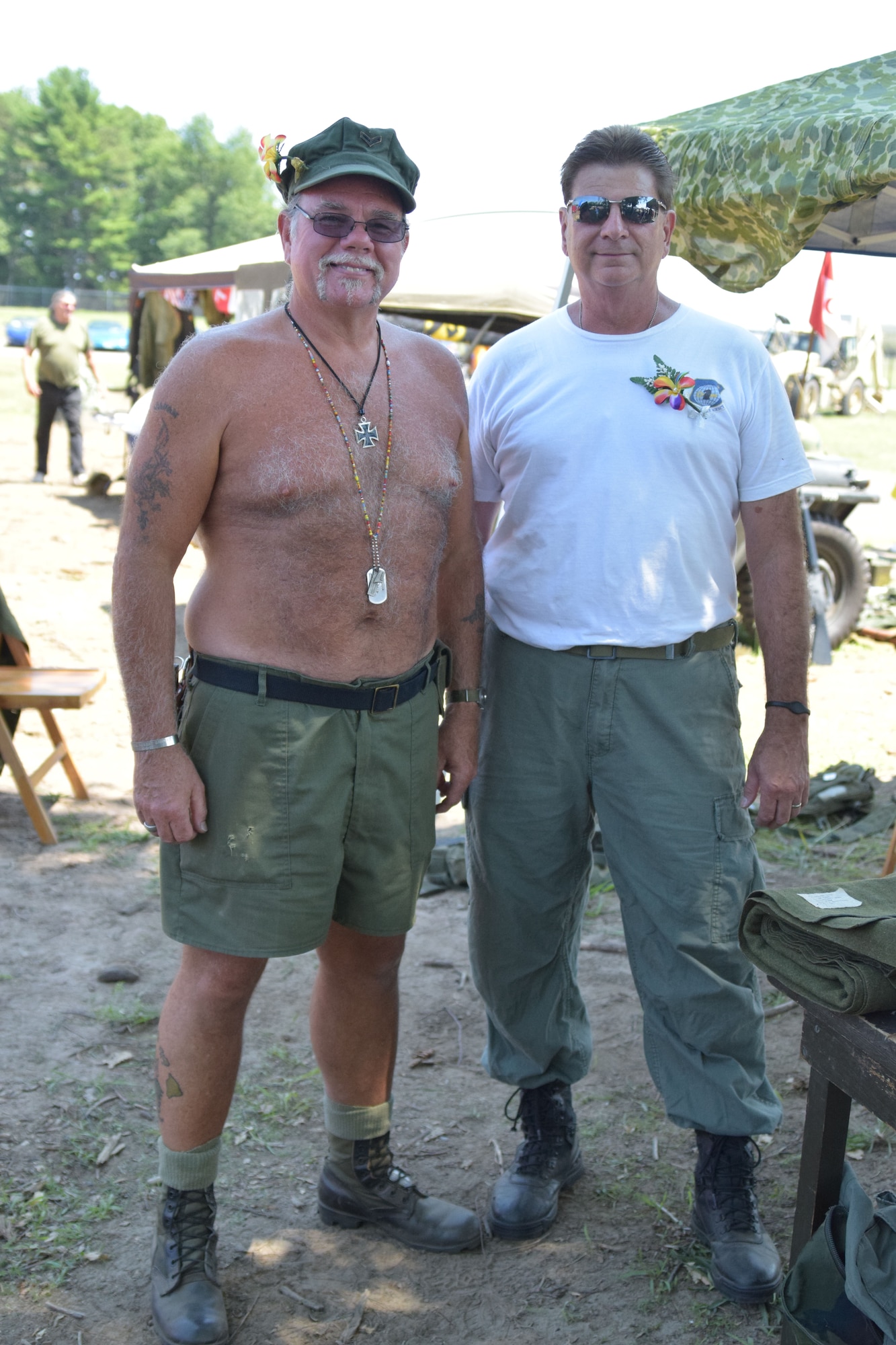 “Seabees don’t wear shirts,” said Mark Crob, who served 28 years in the Navy, which included service in Vietnam. Crob and Rick Telesca exhibited uniforms and gear from the Vietnam era. (Photo by Staff Sgt. Benjamin Simon, JFHQ Public Affairs)