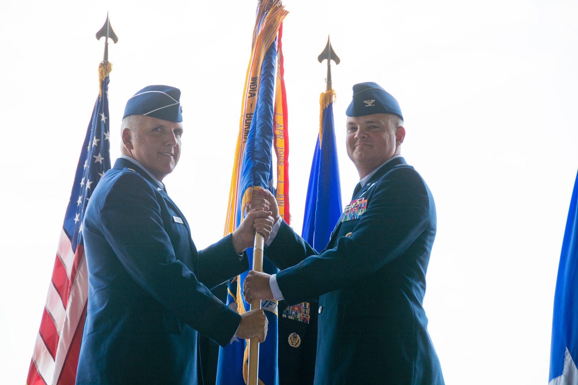 Maj. Gen. John C. Flournoy Jr. (left), 4th Air Force commander, passes the 512th Airlift Wing guidon to Col. D. Scott Durham, Aug. 1, 2015, during a change of command ceremony on Dover Air Force Base, Del. Durham was previously assigned to the Pentagon, where he served as the deputy director for mobilization in the Office of the Assistant Secretary of Defense for Reserve Affairs. (U.S. Air Force photo/Tech. Sgt. Mercedes Crossland)