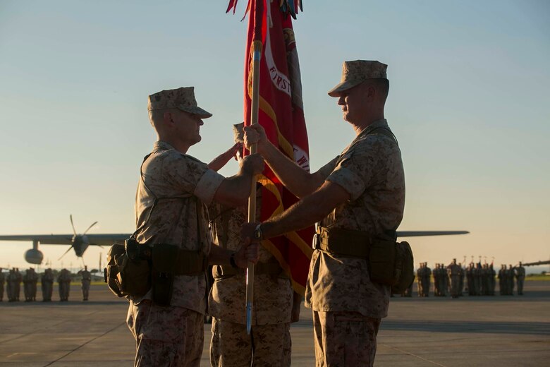 Major Gen. Steven R. Rudder, right, passes the 1st Marine Aircraft Wing colors to Brig. Gen. Russell A. Sanborn during a change of command ceremony at Marine Corps Air Station Futenma, Okinawa, Japan, July 30, 2015. Sanborn recently served as the director of Marine and Family Programs in Quantico, Virginia. Rudder will become the director of J5 Strategic Planning and Policy Directorate, Pacific Command. Sanborn is the new commanding general of 1st MAW, III Marine Expeditionary Force. (U.S. Marine Corps photo by Cpl. Devon Tindle/Released)