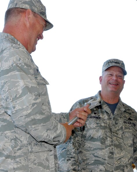 Col. Kirk Peddicord graciously receives the 446th Maintenance Group's coveted commander's wrench from outgoing commander Col. Alan Lerner during a change of command ceremony at Joint Base Lewis-McChord, Wash., Aug. 1, 2015. Peddicord, who's previous assignment was at Headquarters, Air Mobility Command, took command of the 446th MXG from Lerner. Lerner, who arrived at the 446th MXG in September 2011, retired from the Air Force Reserve. (U.S. Air Force photo/2nd Lt. Stephen J. Collier)
