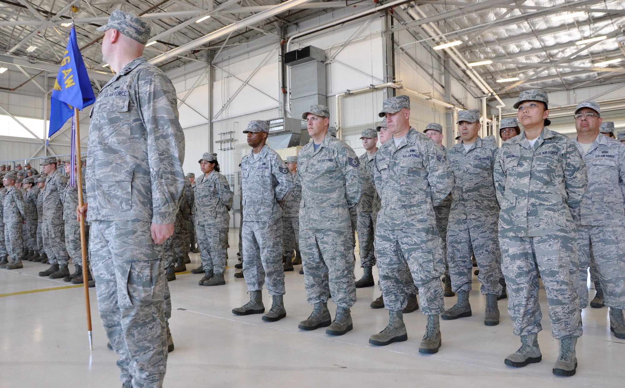 Capt. Jared Adam (left) orders his maintenance Airmen to attention during the 446th Maintenance Group change of command ceremony at Joint Base Lewis-McChord, Wash., Aug. 1, 2015. Outgoing commander Col. Alan Lerner passed the mantle of 446th MXG leadership to Col. Kirk Peddicord, who's previous assignment was at Headquarters, Air Mobility Command. Lerner, who arrived at the 446th MXG in September 2011, retired from the Air Force Reserve. McLaughlin is the commander of the 446th Airlift Wing. (U.S. Air Force photo/2nd Lt. Stephen J. Collier)