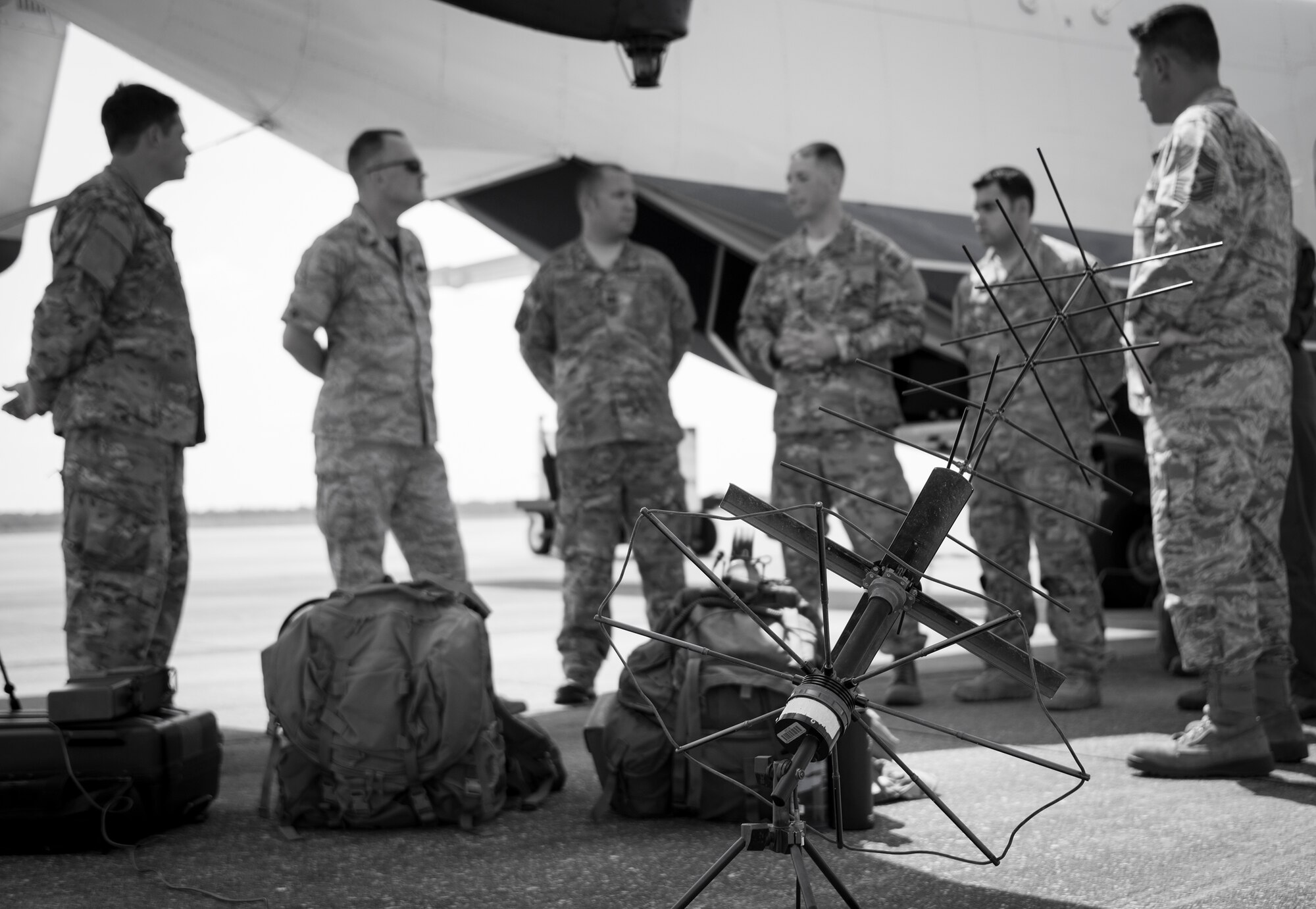 A group of Combat Aviation Advisors explain how they use satellite communications equipment in the field during a Q&A regarding the CAA mission on the C-145 at Duke Field, Fla., Aug. 1, 2015.  Duke Field's Air Force Reserve and active duty Airmen deploy to partner nations to train personnel to engage in air operations. (U.S. Air Force photo/Tech. Sgt. Jasmin Taylor)