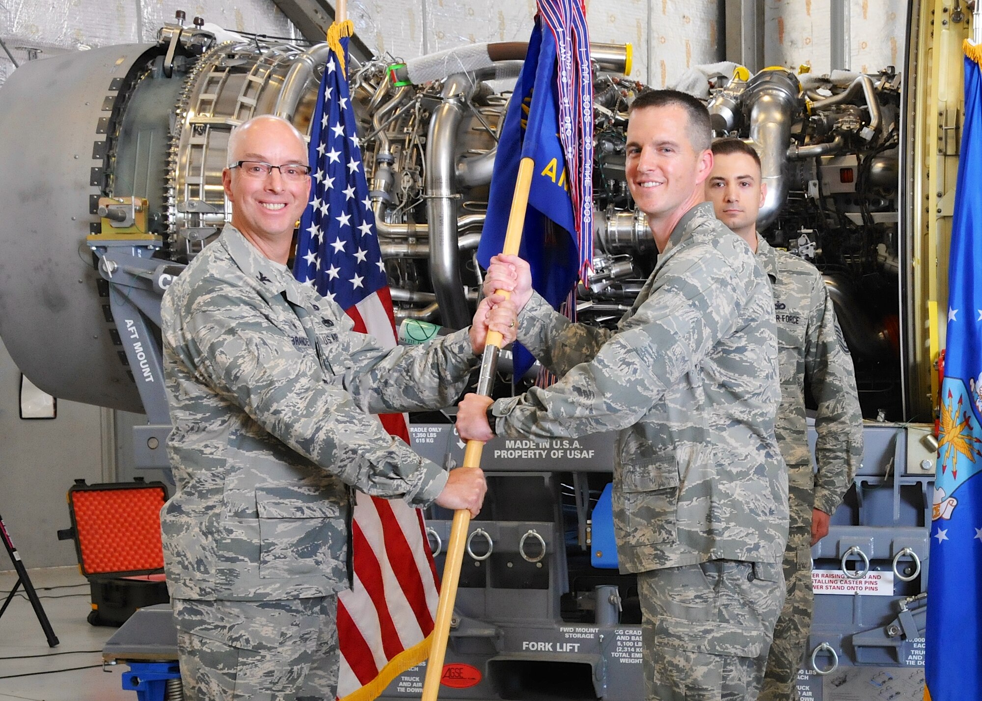 Col. Eric W. Brandes (left), 512th Maintenance Group commander, passes the 512th Aircraft Maintenance Squadron guidon to Maj. Christopher Ryan, Aug. 2, 2015, during a change of command ceremony on Dover Air Force Base, Del. Ryan was previously assigned to the Pentagon, where he served as aide de camp to the commander, Air Force Reserve Command and Chief of the Air Force Reserve. (U.S. Air Force photo/2nd Lt. Steve Lewis)
 
