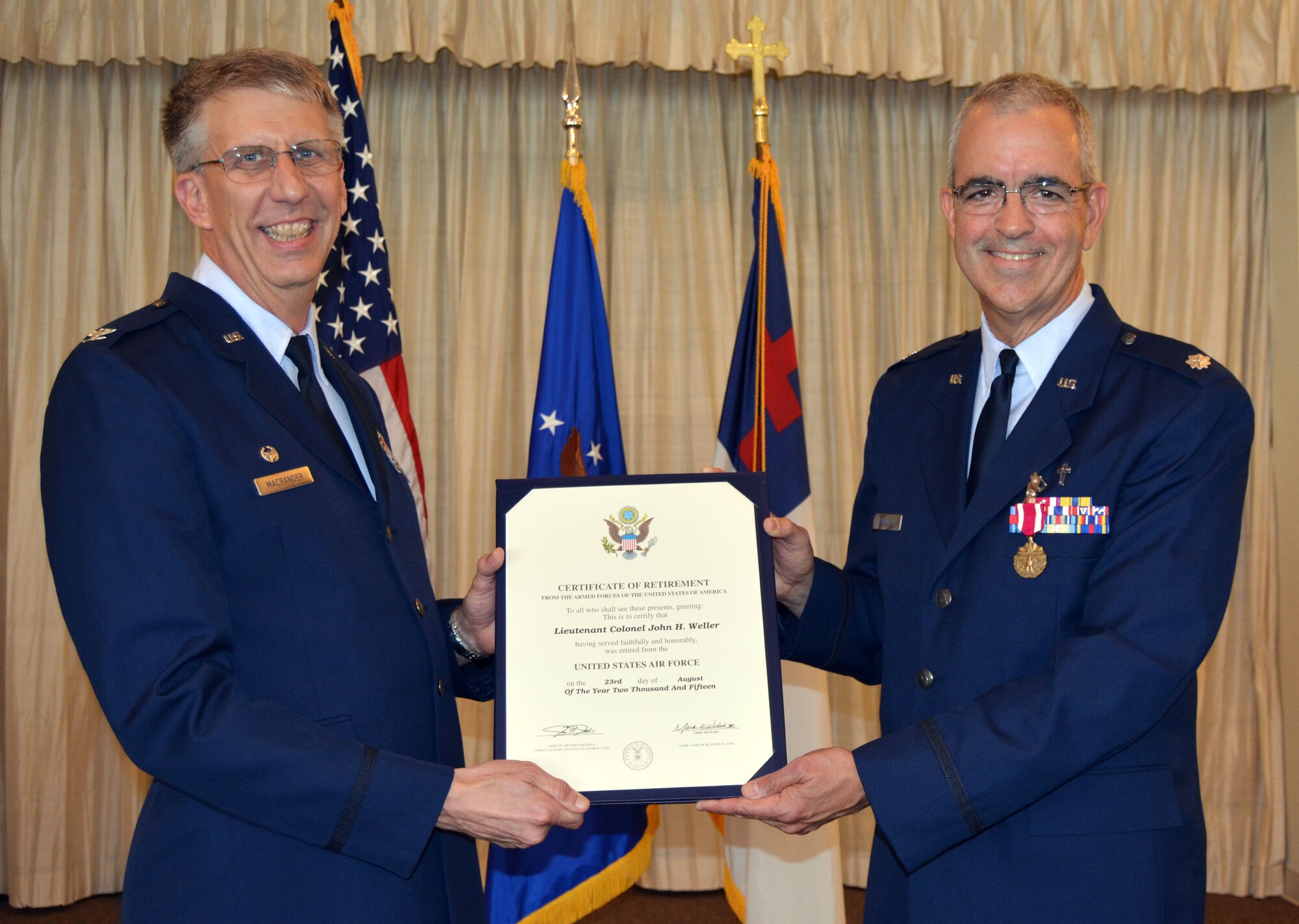 Col. Jeffrey Macrander, 920th Rescue Wing commander, presents a certificate of retirement to Chaplain (Lt. Col.) John Weller during his retirement ceremony Aug. 1 at the Patrick Air Force Base, Fla., chapel. Weller served as an Air Force chaplain for 27 years, 12 of which were as a reservist at Patrick. (U.S. Air Force photo/2nd Lt. Anna-Marie Wyant)
