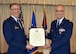 Col. Jeffrey Macrander, 920th Rescue Wing commander, presents a certificate of retirement to Chaplain (Lt. Col.) John Weller during his retirement ceremony Aug. 1 at the Patrick Air Force Base, Fla., chapel. Weller served as an Air Force chaplain for 27 years, 12 of which were as a reservist at Patrick. (U.S. Air Force photo/2nd Lt. Anna-Marie Wyant)