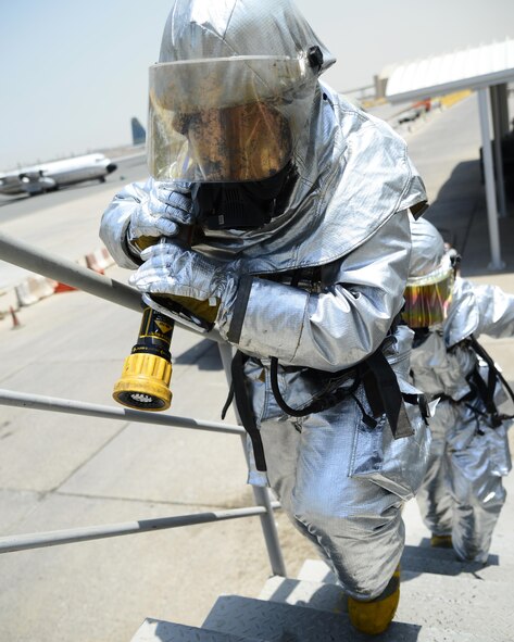 U.S. Air Force Senior Airmen David Geil and Abraham Barragnon, 387th Civil Engineer Squadron firefighters, respond to a simulated drill during Operation INHERENT RESOLVE at an undisclosed location in Southwest Asia, July 30, 2015. Due to Airmen’s dedication to the mission, ISIL can no longer operate freely in roughly 25 to 30 percent of populated areas of Iraqi territory where it once could. (U.S. Air Force photo by Senior Airman Racheal E. Watson/Released)