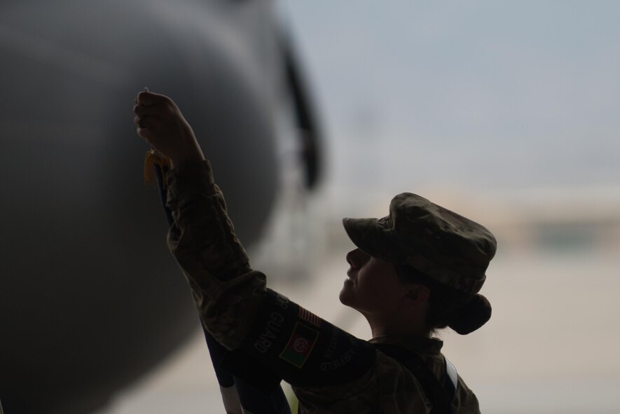A U.S. Airman with the Bagram Airfield Honor Guard makes final adjustments to the U.S. Flag before the 455th Expeditionary Operations Group change of command ceremony at Bagram Airfield, Afghanistan, Aug. 3, 2015. The 455th EOG is responsible for all expeditionary flying and aeromedical evacuation operations for the 455th Air Expeditionary Wing. (U.S. Air Force photo by Tech. Sgt. Joseph Swafford/Released)