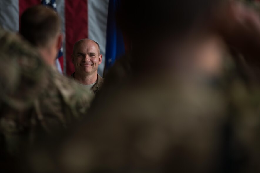 U.S. Air Force Col. Henry Rogers, 455th Expeditionary Operations Group incoming commander, smiles after receiving his first salute as the 455th EOG commander during the 455th EOG change of command ceremony at Bagram Airfield, Afghanistan, Aug. 3, 2015. The 455th EOG is responsible for all expeditionary flying and aeromedical evacuation operations for the 455th AEW. (U.S. Air Force photo by Tech. Sgt. Joseph Swafford/Released)