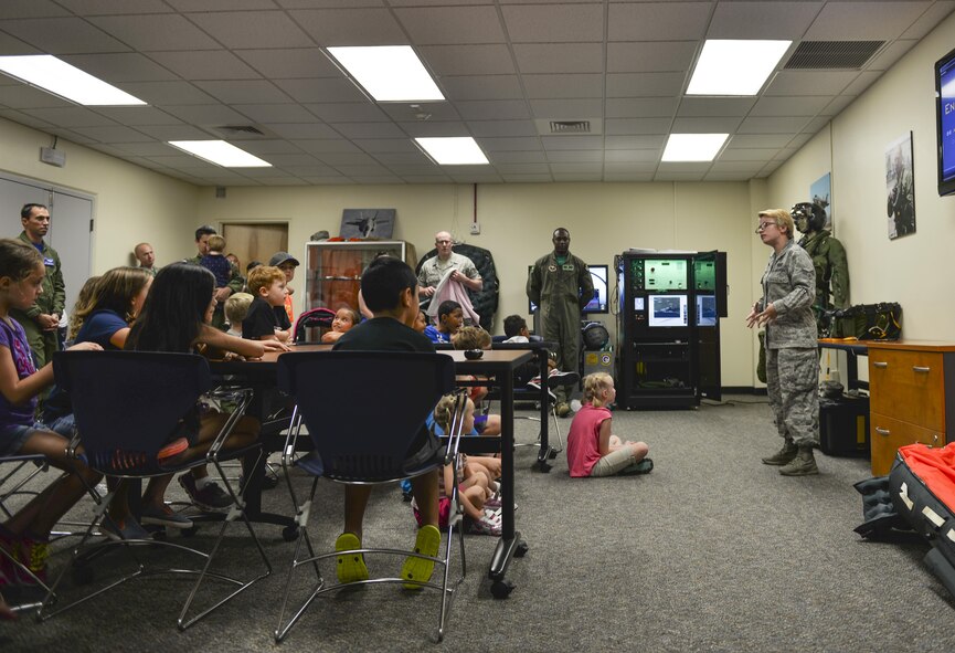 Senior Airman Sean Gregory, 33rd Operations Support Squadron aircrew flight equipment technician, gives a presentation to 33rd Operations Support Squadron and 58th Fighter Squadron families for “Bring your family to work day” at Eglin Air Force Base, Fla., July 31, 2015. The 33 OSS and 58 FS hosted this event to show families their jobs in the Air Force. (U.S. Air Force Photo/Senior Airman Andrea Posey)