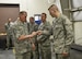 Airman 1st Class Cody Birnschein, 33rd Maintenance Squadron aircraft metals technician journeyman, gives Chief Master Sgt. of the Air Force James Cody his squadron’s coin at Eglin Air Force Base, Fla., July 30, 2015. Cody visited Eglin AFB to touch base with Airmen in the 33rd Fighter Wing and the 96th Force Support Squadron. (U.S. Air Force Photo/Senior Airman Andrea Posey)
