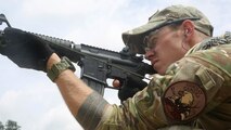 U.S. Air Force Staff Sgt. Sam Weaver, a Combat Camera Airman, assigned to the 1st Combat Camera Squadron, shoots his M4 carbine rifle during the 3rd Annual Spc. Hilda I. Clayton Best Combat Camera (COMCAM) Competition qualification range at Fort George G. Meade, Md., July 14, 2015. Weapons qualification is conducted on day two of the Spc. Hilda I. Clayton Best COMCAM Competition, where teams of two compete throughout a weeklong event that assesses the technical and tactical skills of visual information personnel. The Competition is established in honoring fallen combat camera Soldier Spc. Hilda I. Clayton, who gave her life July 2, 2013, in Afghanistan as a part of Operation Enduring Freedom. (U.S. Army photo by Staff Sgt. Kwadwo Frimpong/Released)