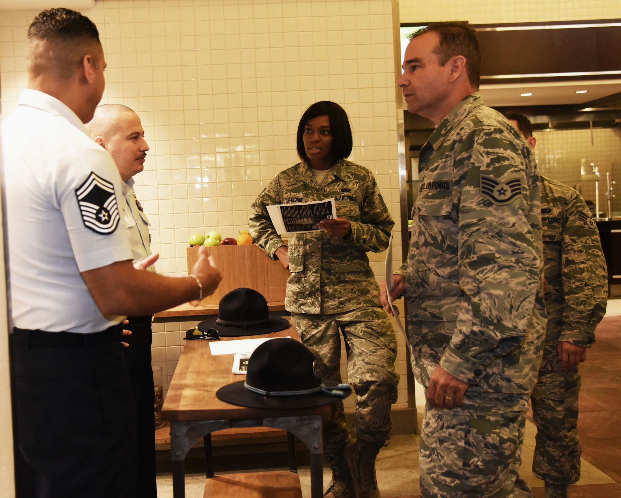Senior Master Sgt. Ricardo Chavez and Tech. Sgt. Jesse Garcia, Military Training Instructor assigned to the 433rd Training Squadron, Lackland Air Force Base, Texas, talk with MacDill reservists at the Dining Facility, August 1, 2015. The MTIs attended the 927th Air Refueling Wing August Unit Training Assembly to advise reservists about opportunities to join the MTI Corps. Within the MTI corps there is many positions available for Staff Sgts. to Master Sgts. (U.S. Air Force Photo by Staff Sgt. Adam C. Borgman)